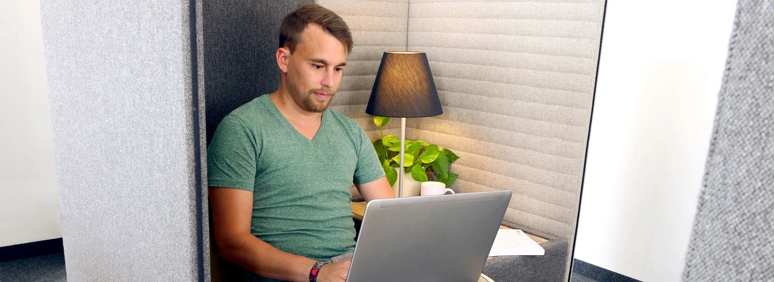 Man ruminating in office cubicle due to perfectionism