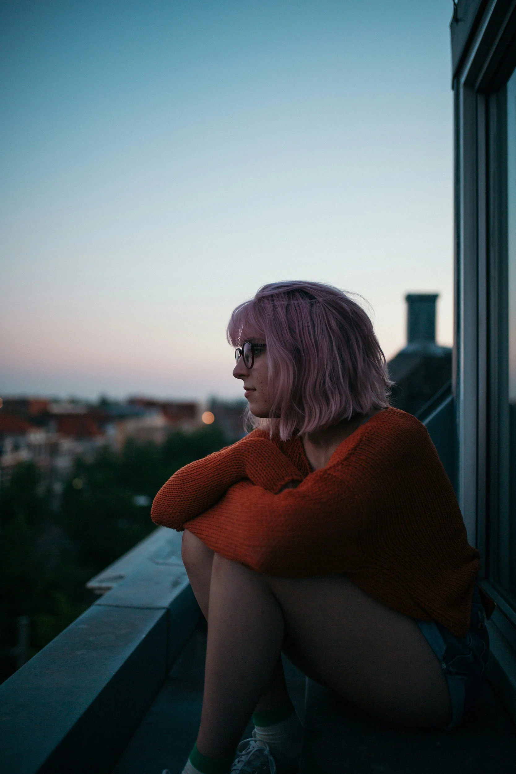 Woman calmly sitting outside on balcony