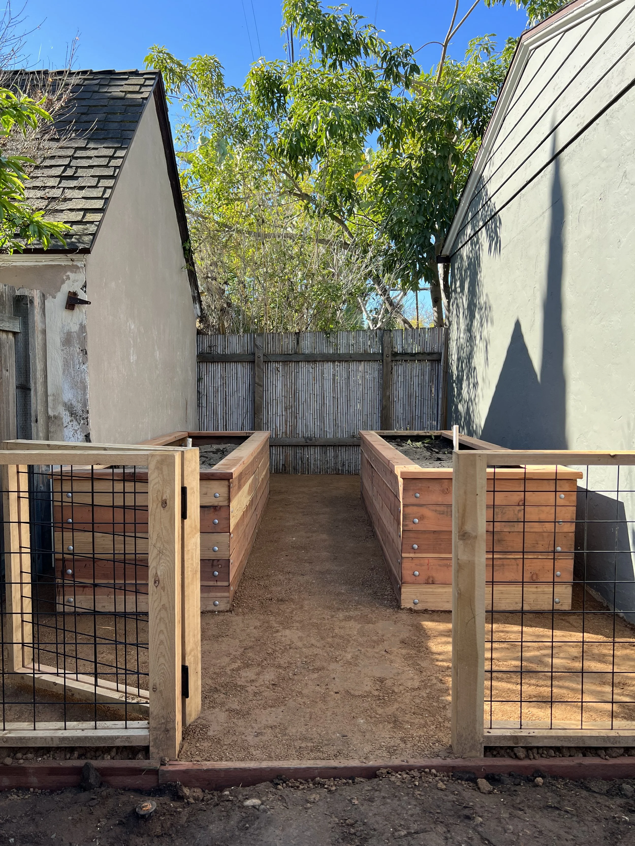 custom garden area with drip irriagation, cedar raised garden beds, fence, and premium compost