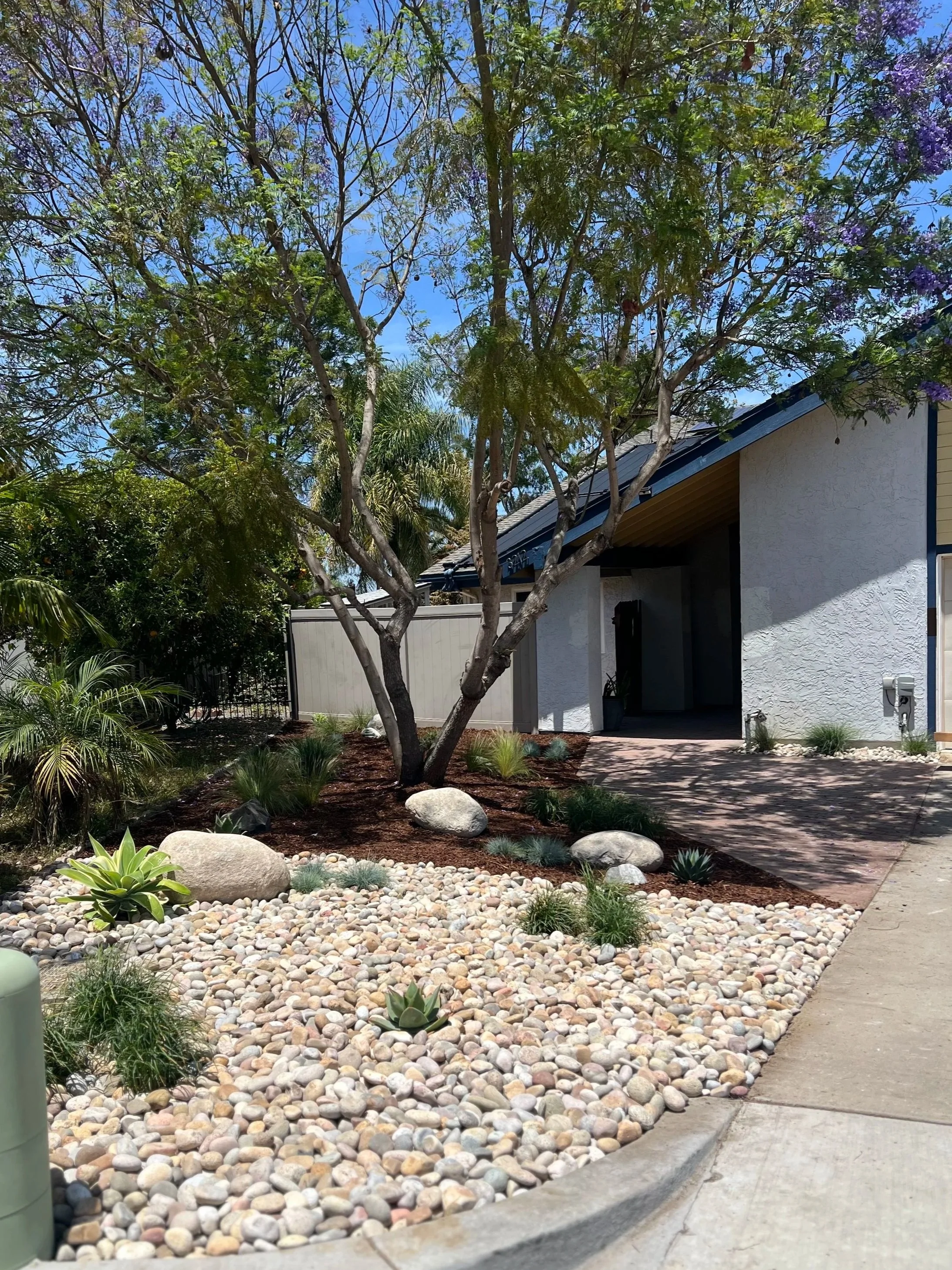 Front yard remodel with concrete, mulch, boulders, rocks, plants