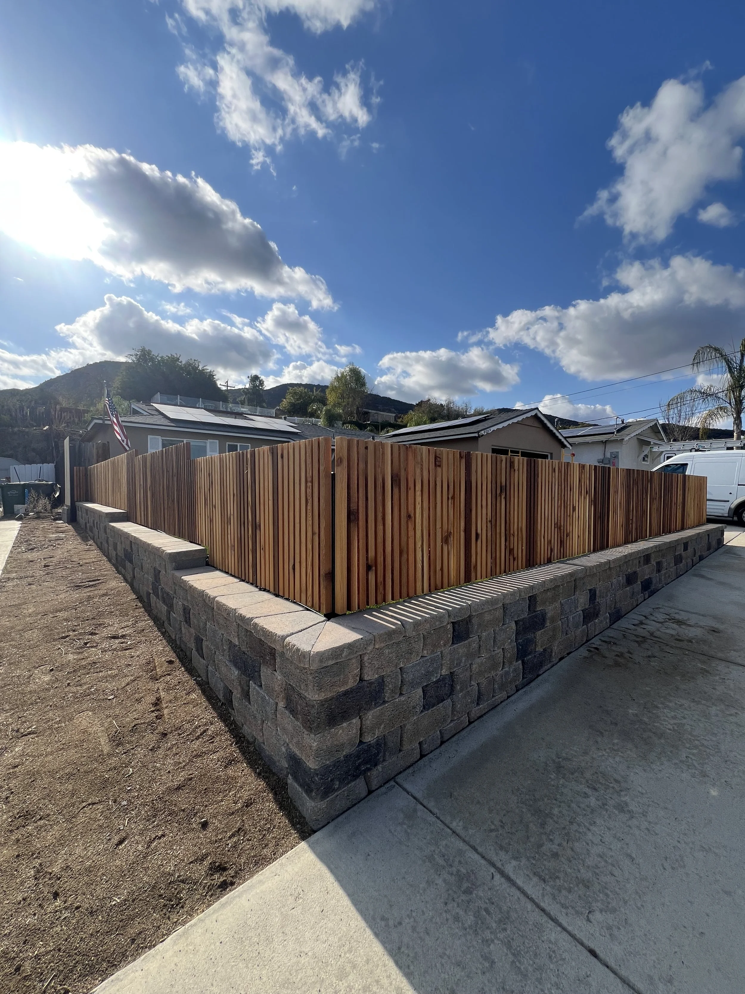 front yard retaining wall with vertical privacy fence.