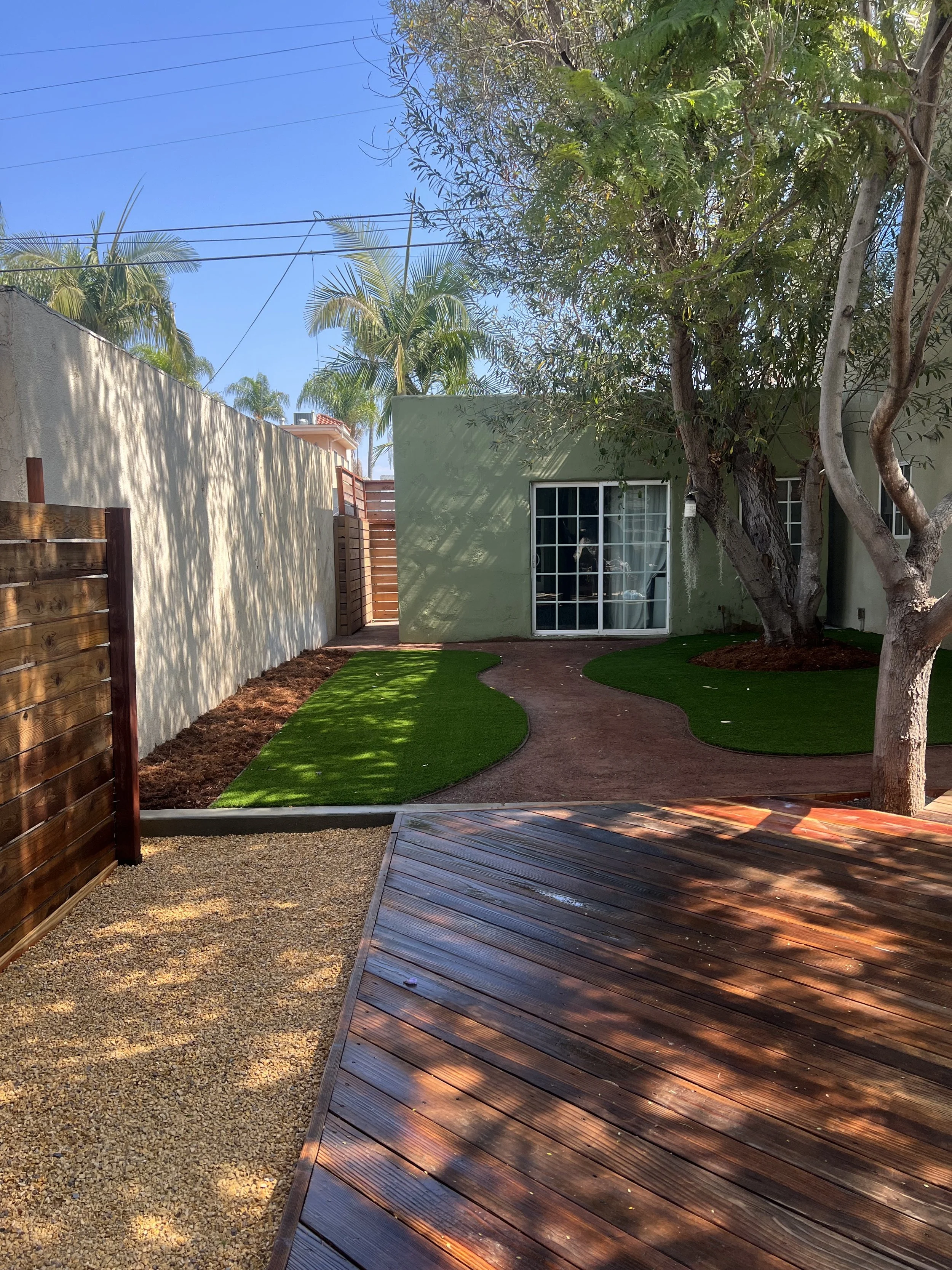 finished backyard with wood deck, dg, and turf