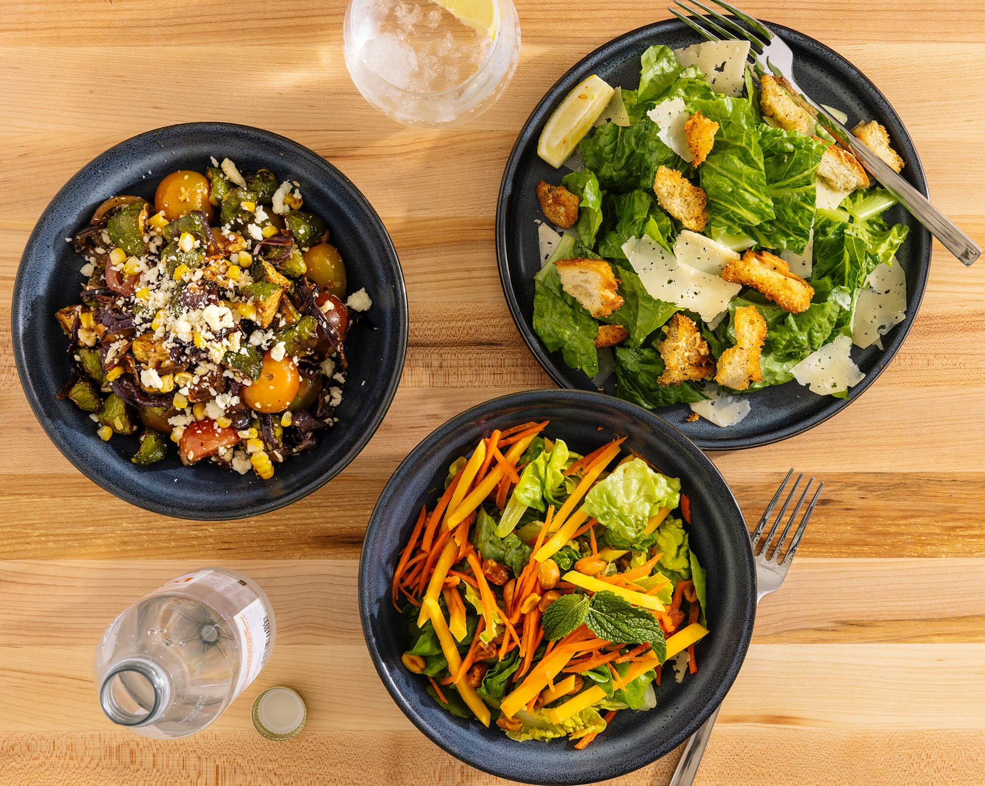   Three fresh, healthy salads arranged on a table  