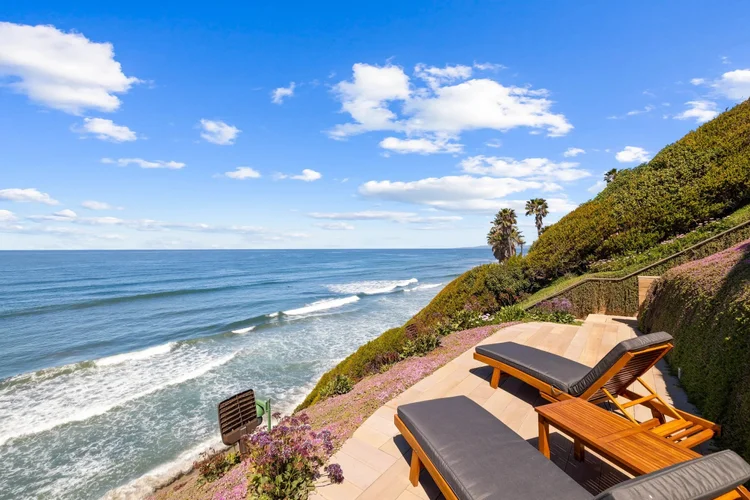 Ocean-view patio with lounge chairs