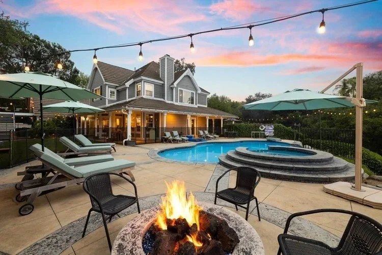 Backyard pool and fire pit at twilight