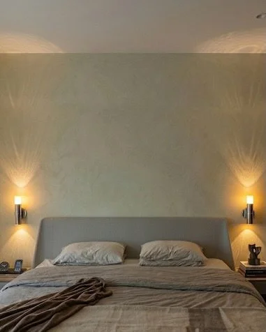 Custom STIRIA Wall Lights bringing a soft, luminous presence for this bedroom retreat.

Crafted from recycled forged glass, each kiln-formed silhouette captures and holds light within, creating a frozen internal glow. Emitting light both upward and d