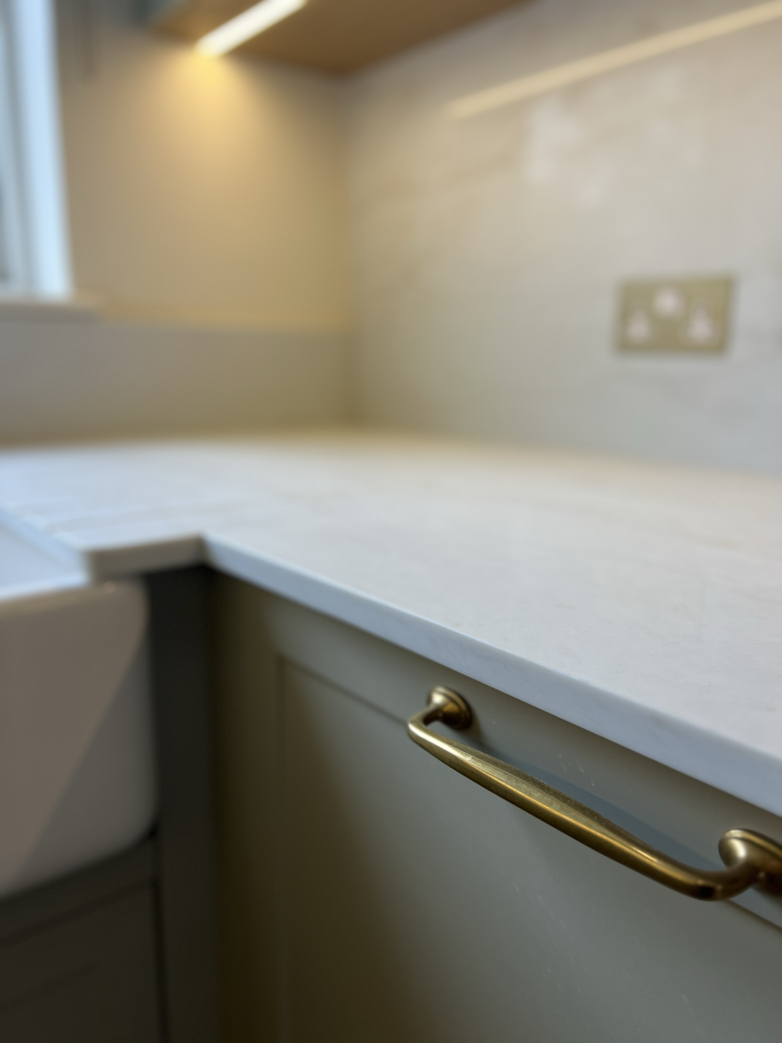 “Bespoke kitchen design with shaker-style cabinets, stone countertops, and integrated appliances.”