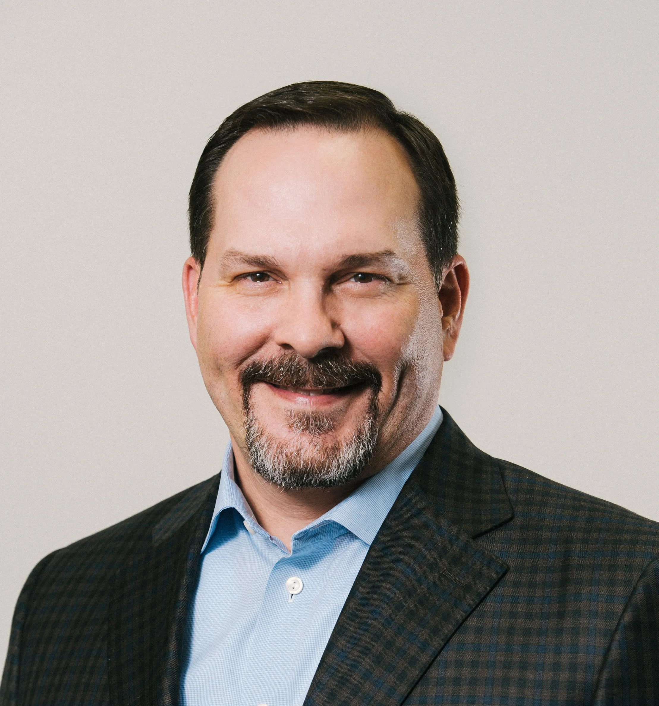 Smiling male thriller author Joe Betar wearing a sports coat