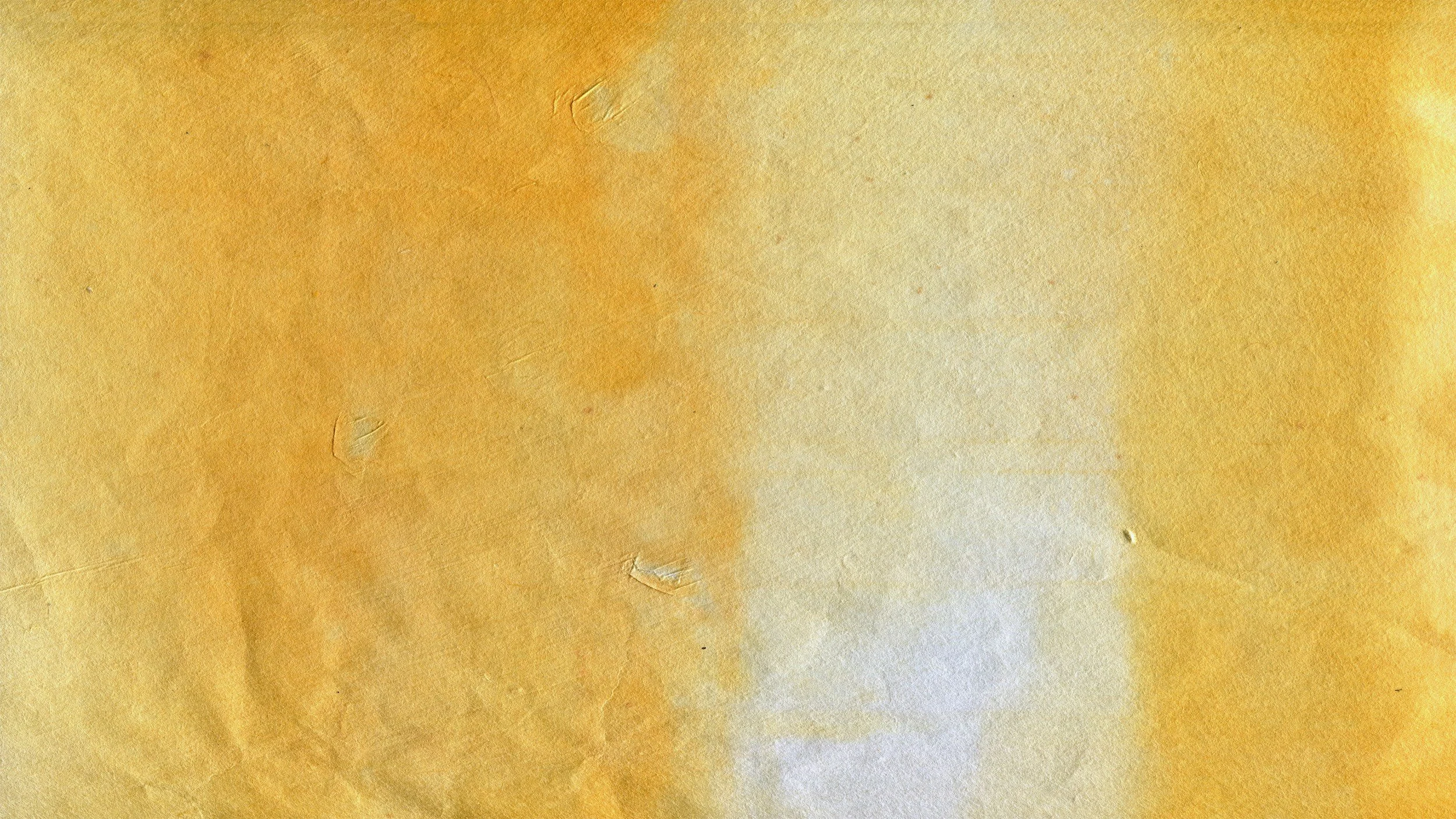 Close-up of a textured, yellowish parchment or paper with a subtle gradient and some visible fibers and minor imperfections.