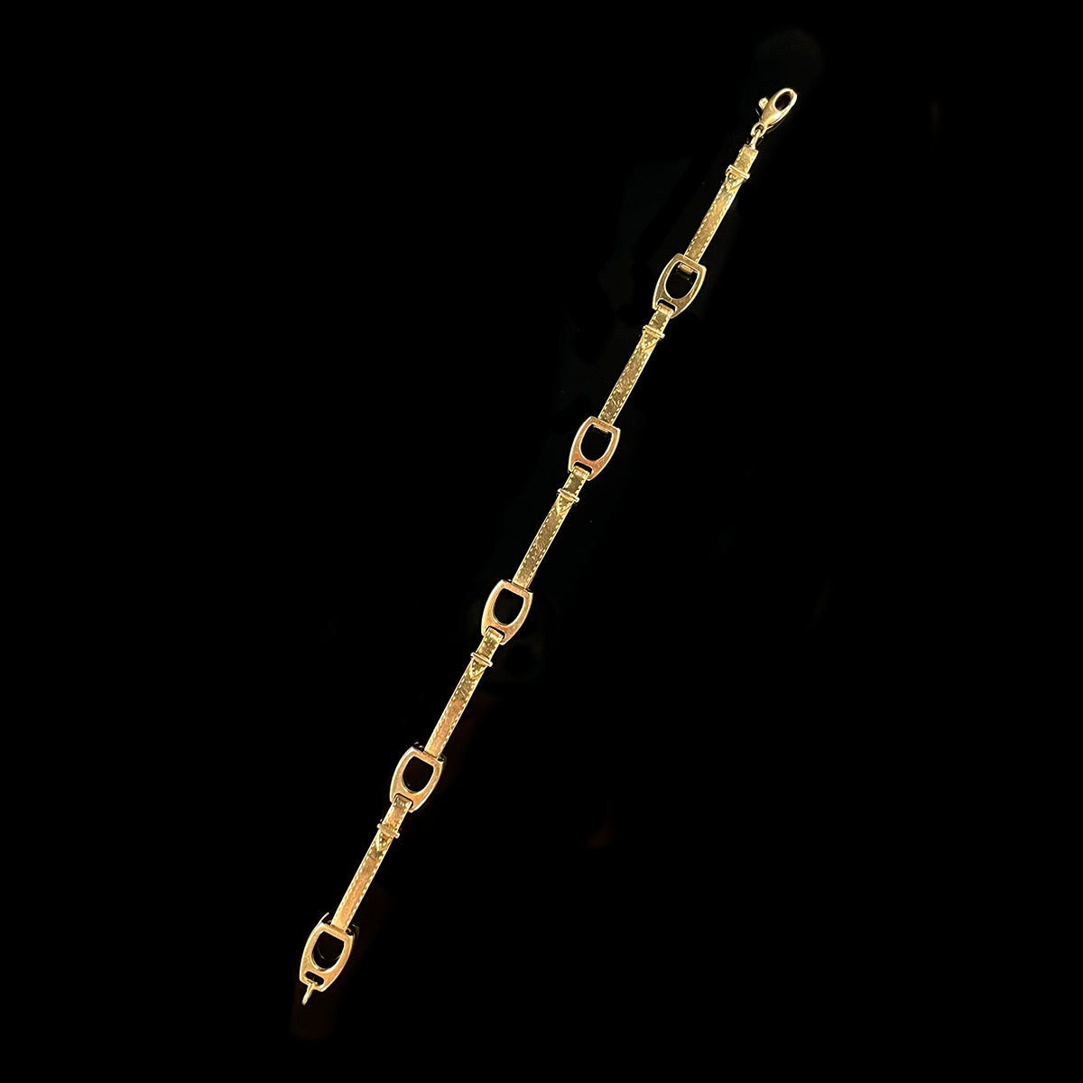 18K Yellow Gold Stirrup Bracelet Layed Out.png