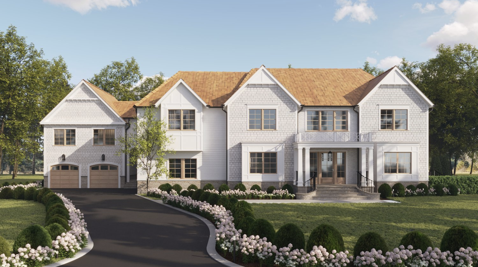 Front view of a large white house with a brown shingled roof, surrounded by green lawns and flower beds, with trees in the background and a curved driveway leading to the garage and main entrance.