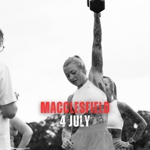 A woman raising a torch or flame at a public event with other people around, promoting Macclesfield on July 4th.