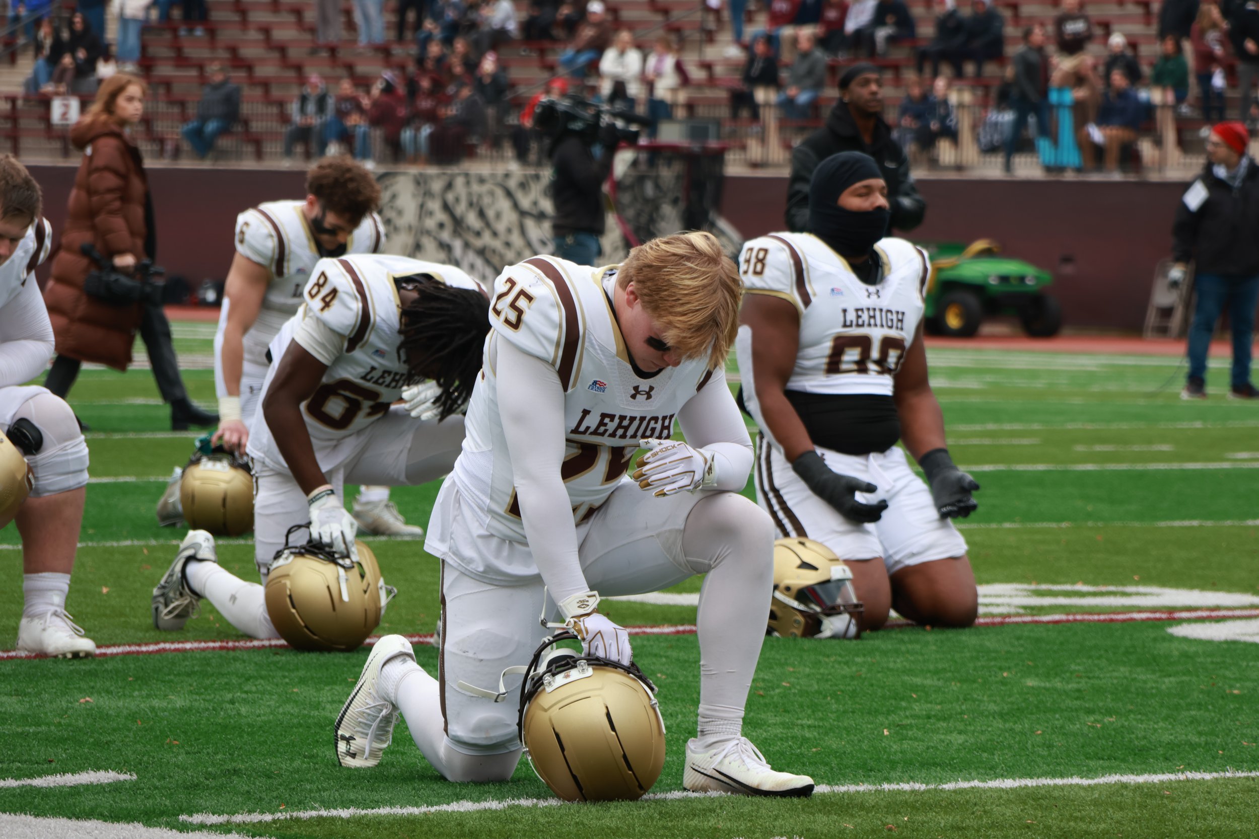 Lehigh football defensive back Austin Quandt takes a knee before kick-off of the team's rivalry game against Lafayette.