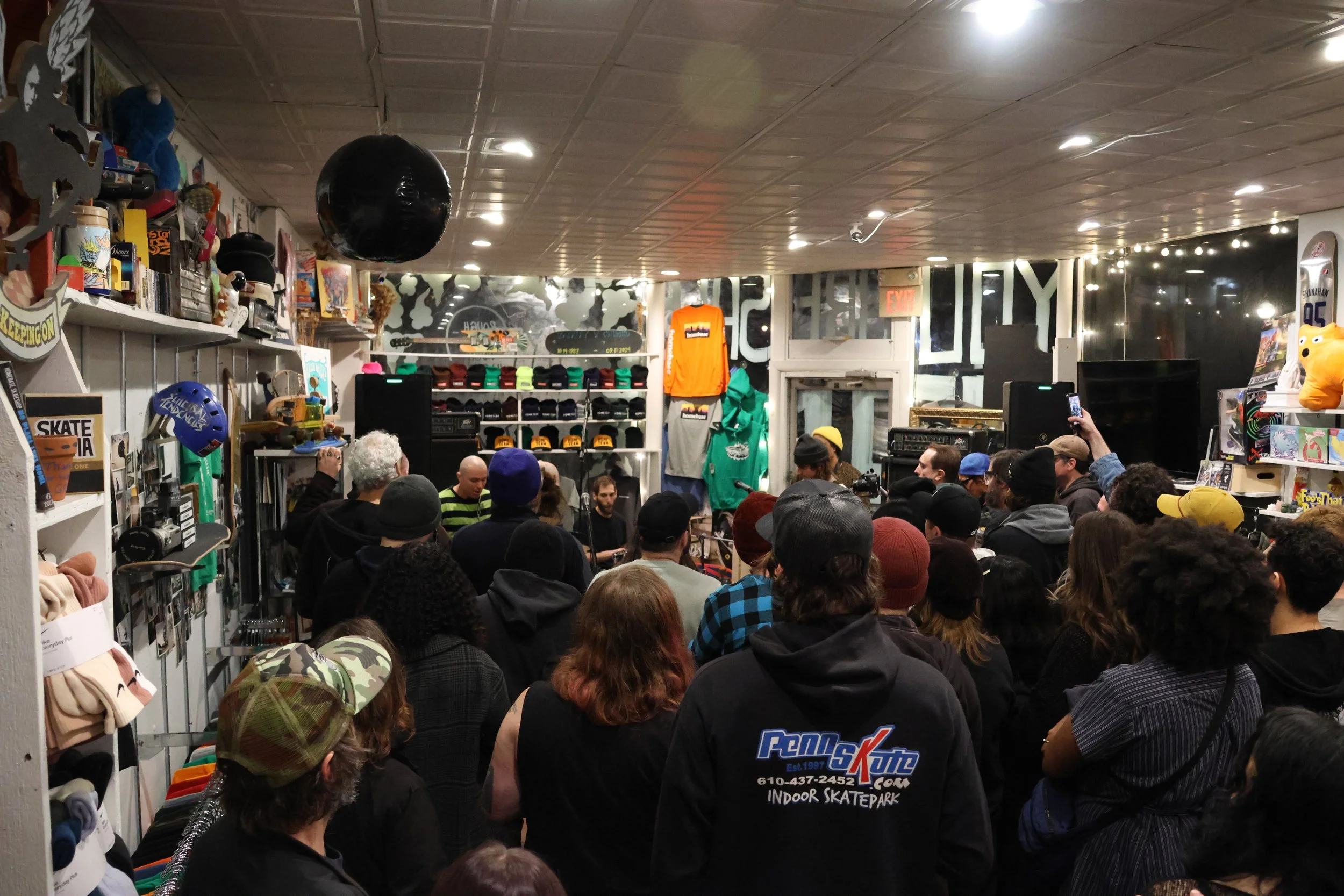 A large crowd of skaters and non-skaters watch skate punk band Headzo perform a set at the Homebase Skateshop during Skate Shop Day weekend. The live concert and session recording was one of five events the shop hosted to celebrate the day. (Luke Kai