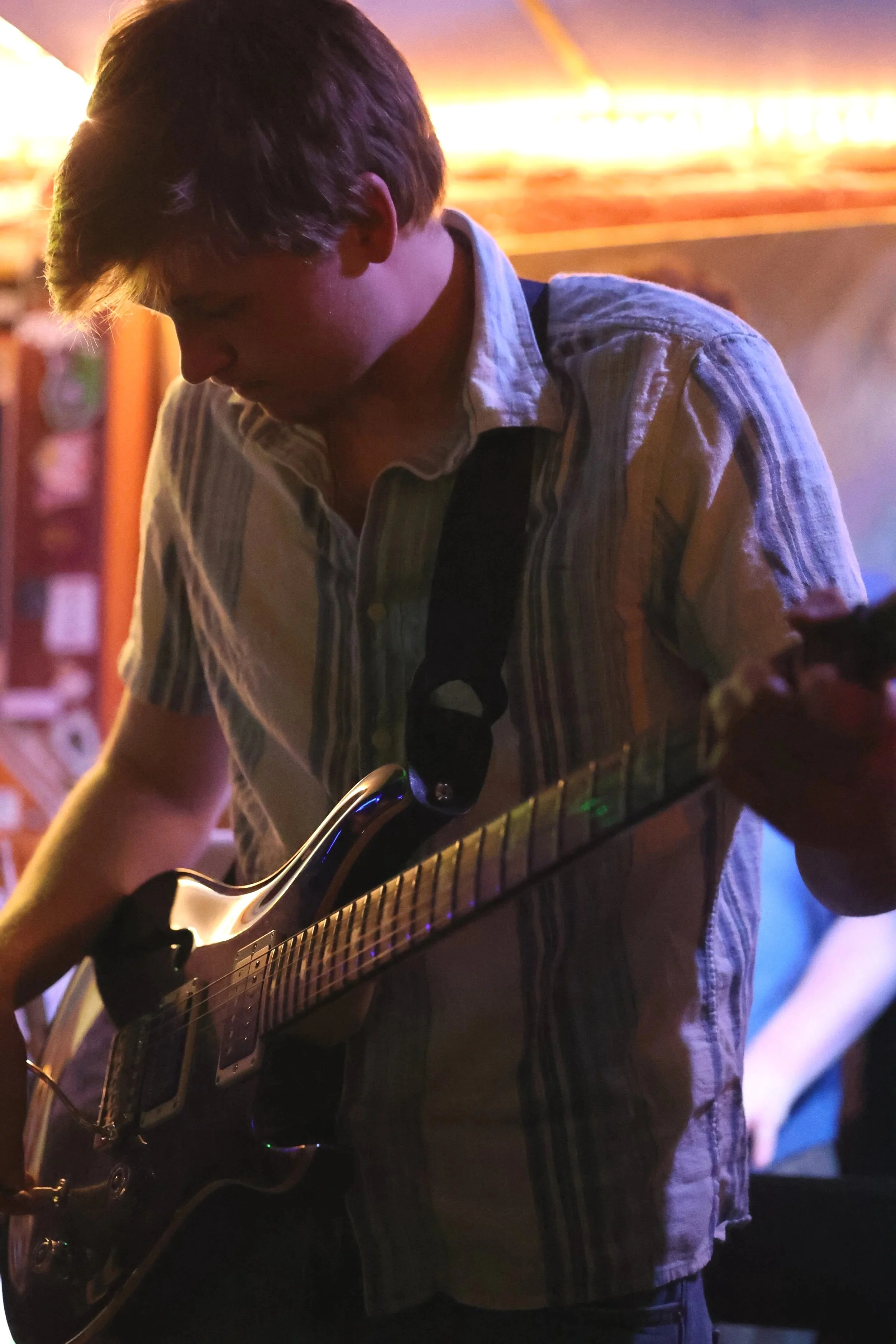 Owen Hale plays his guitar during a live performance. (Luke Kaiser)
