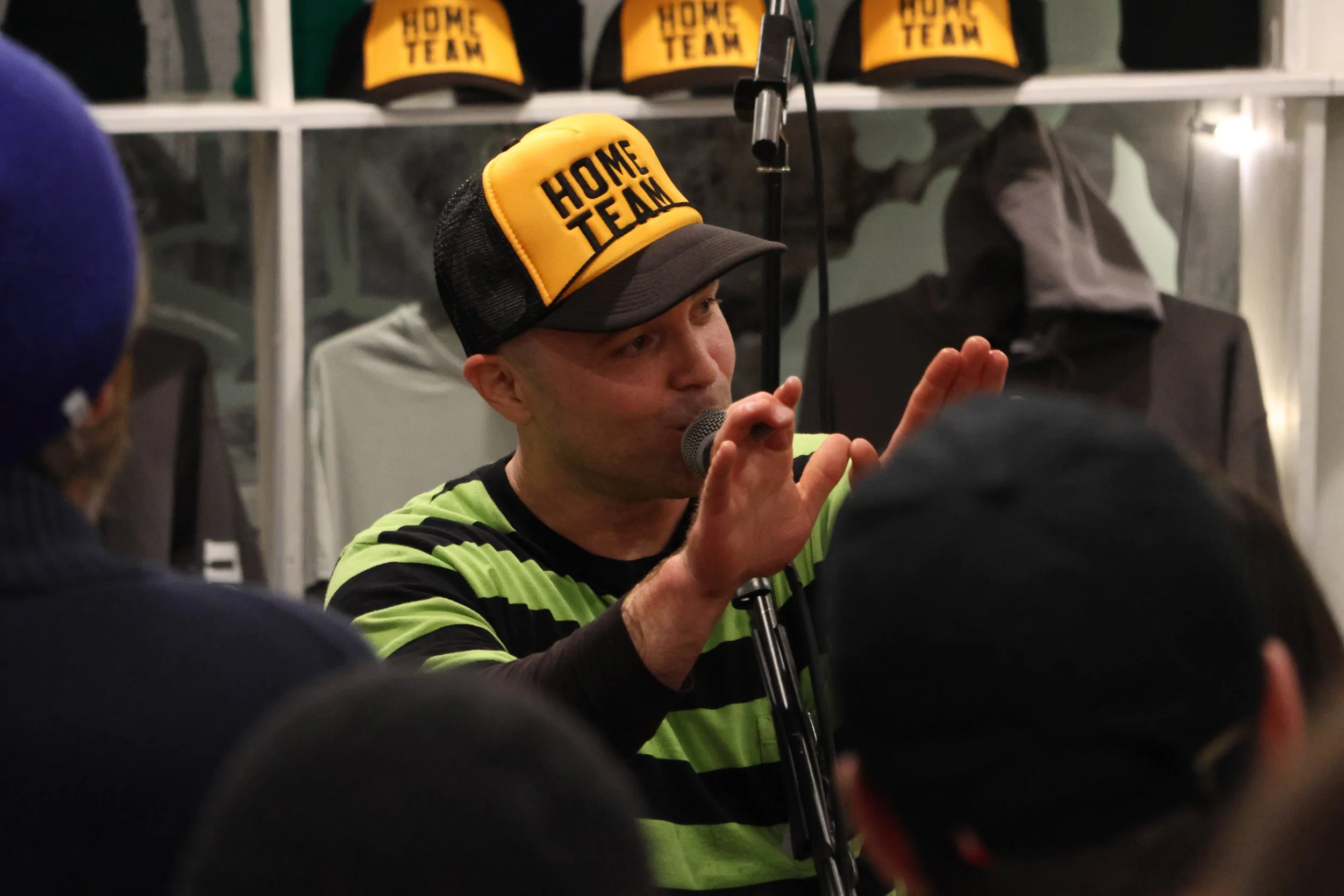 Chris Devlin, lead singer of skate punk band Headzo, talks to the crowd during a performance at the Homebase Skateshop.