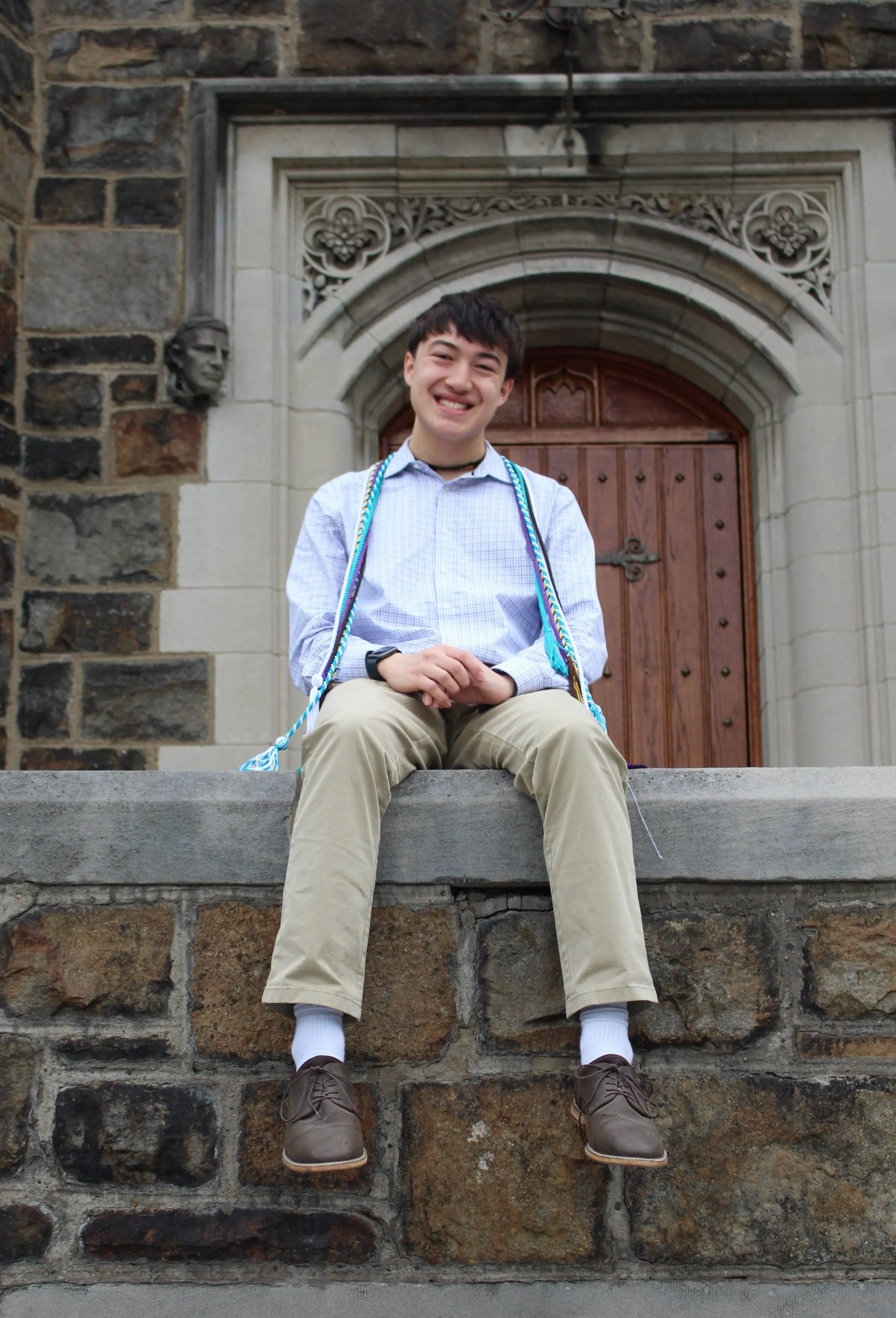 Luke Kaiser sitting on Lehigh's Alumni Memorial Building.