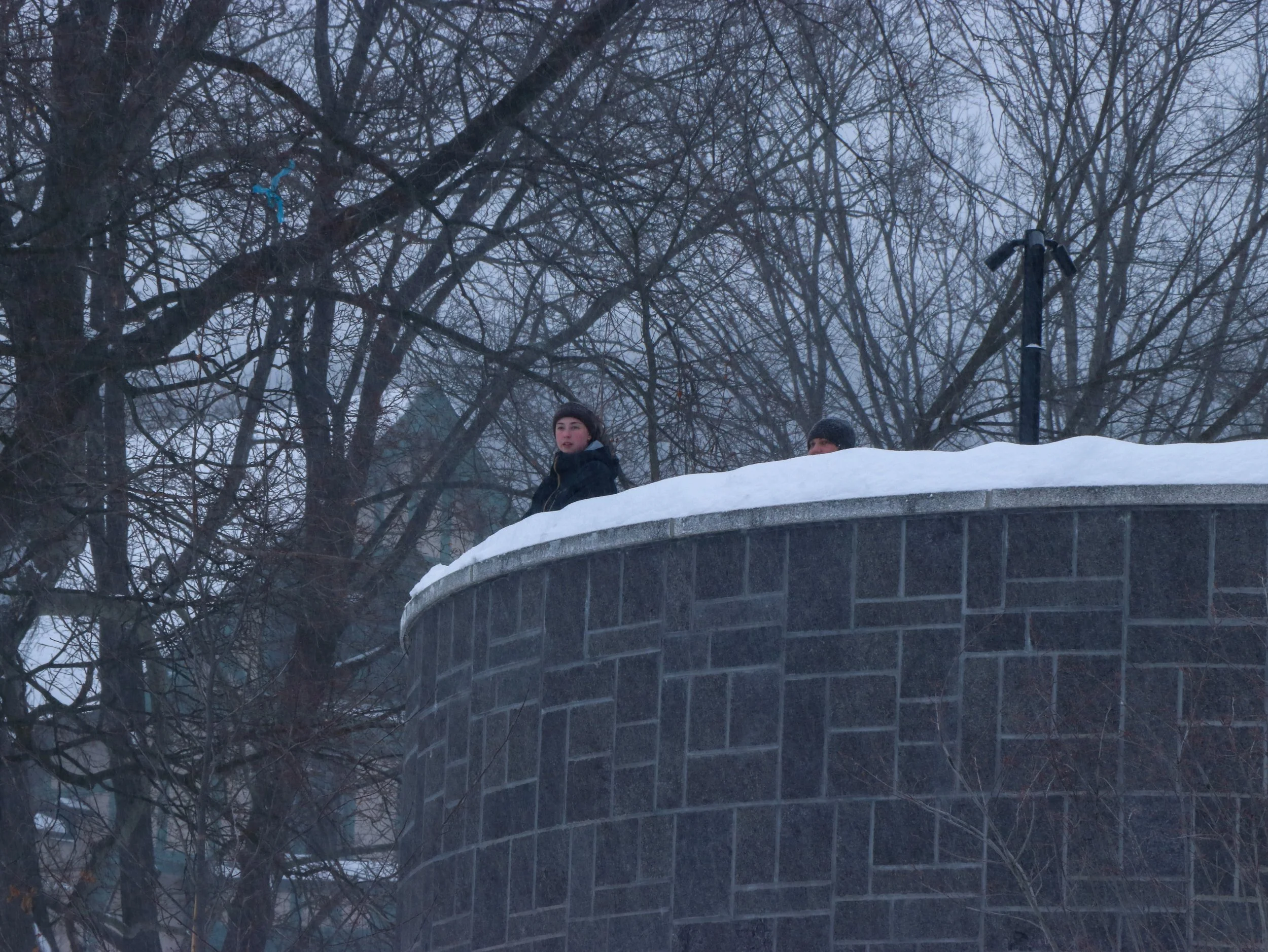Students overlook at the snow coverage from the Clayton University Center's fire pit after a major snowstorm canceled classes. (Luke Kaiser/B&W Staff)