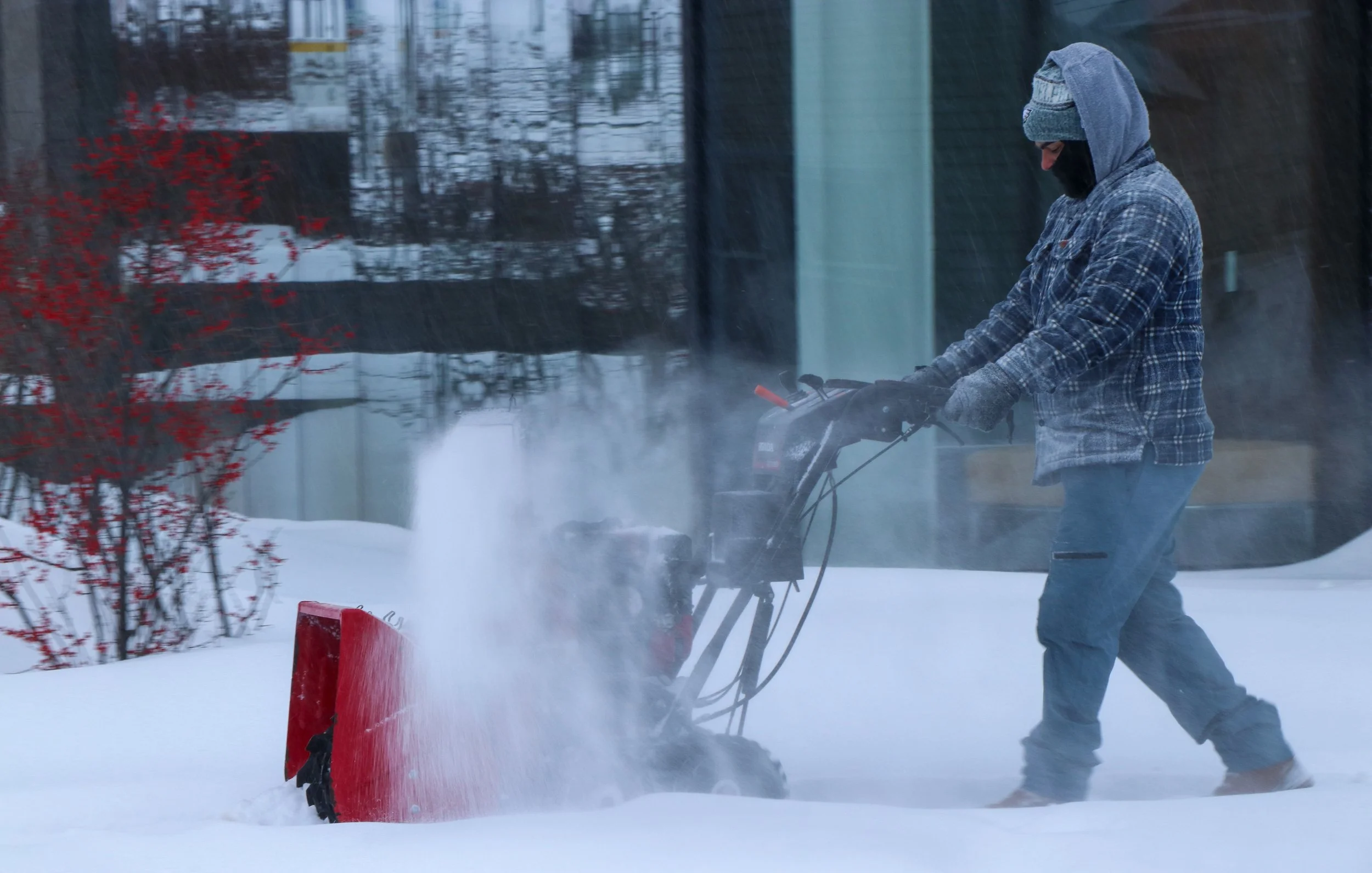 A Bethlehem community member is pictured snowplowing the sidewalk outside the Health, Science and Technology building. Lehigh moved to remote classes amid the snow-covered sidewalks and roads.  (Luke Kaiser/B&W Staff)