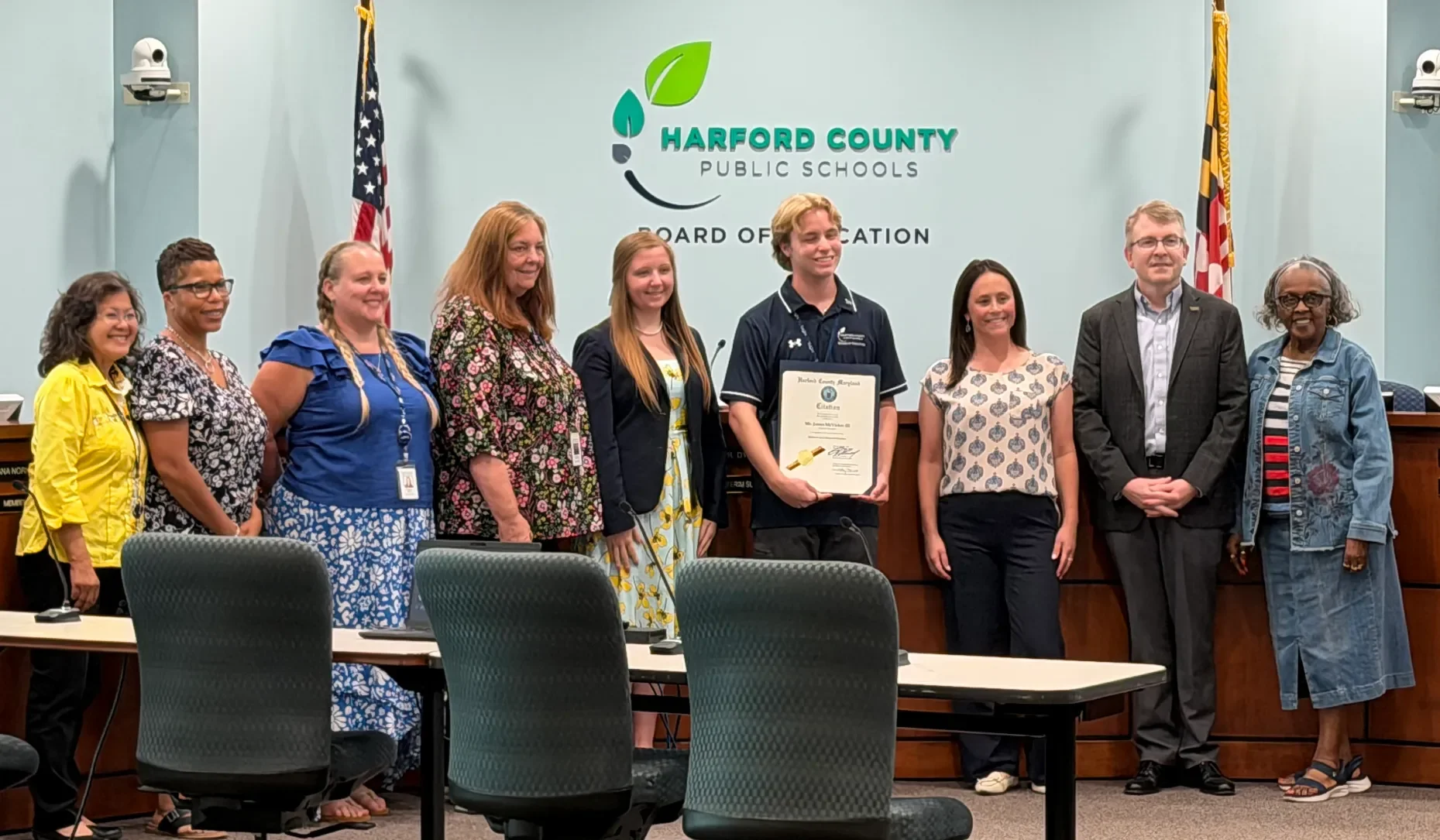 The Harford County Public Schools Board of Education stands to honor student member James “Trae” McVicker III’s service. At its Monday meeting, the Board of Education finalized budget cuts to resolve a $12.5 million deficit. (Luke Kaiser/Staff)