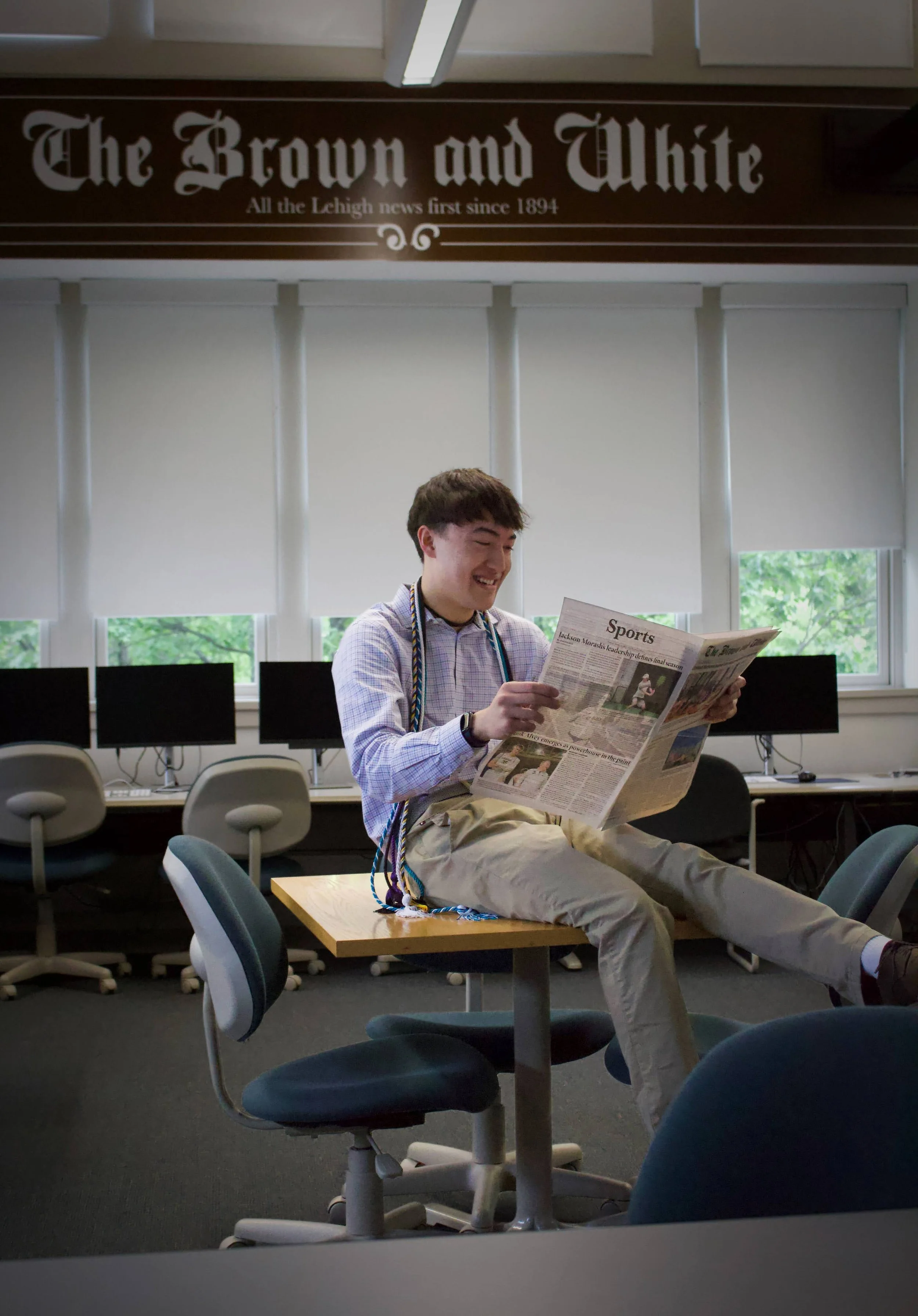 Luke Kaiser reads an issue of The Brown and White, Lehigh University's student-run newspaper, in the Coppee Hall newsroom.