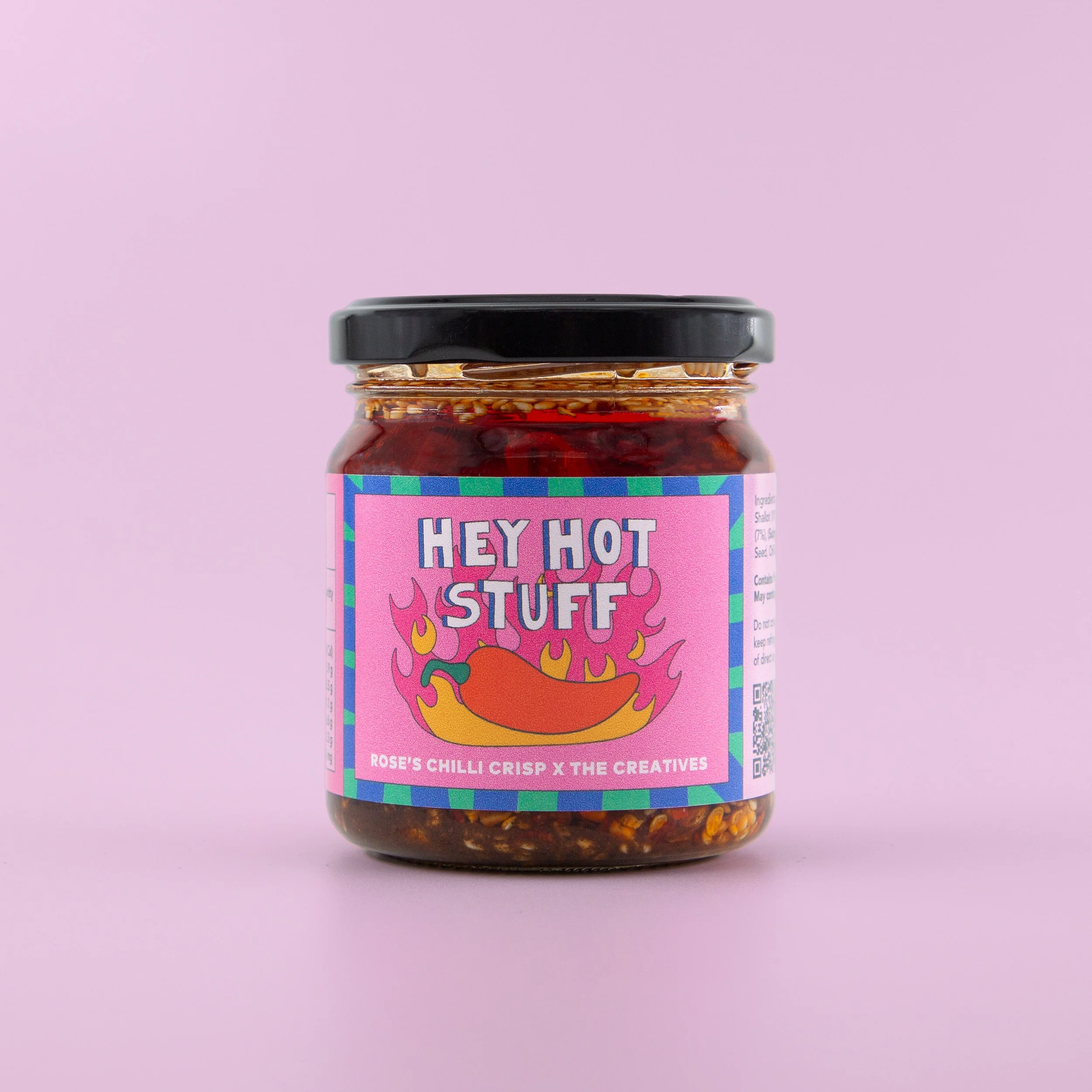 Example of graphic design from The Creatives' with a jar of "Hey Hot Stuff" chili crisp with a pink label featuring a flaming chili graphic.