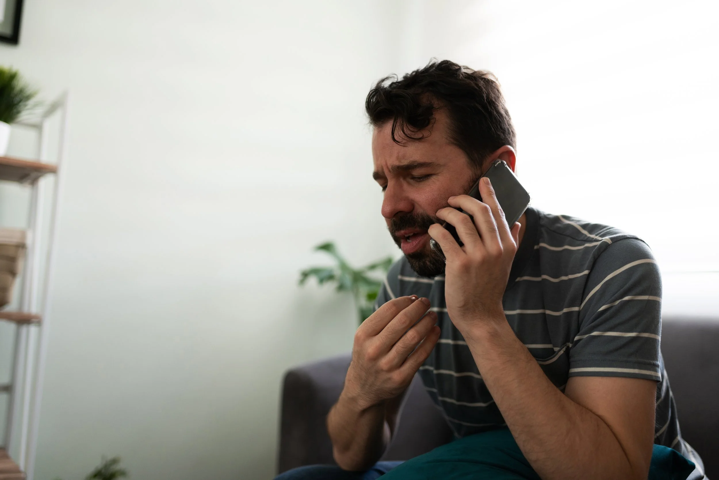 Man on the phone calling a doctor about costs without health insurance