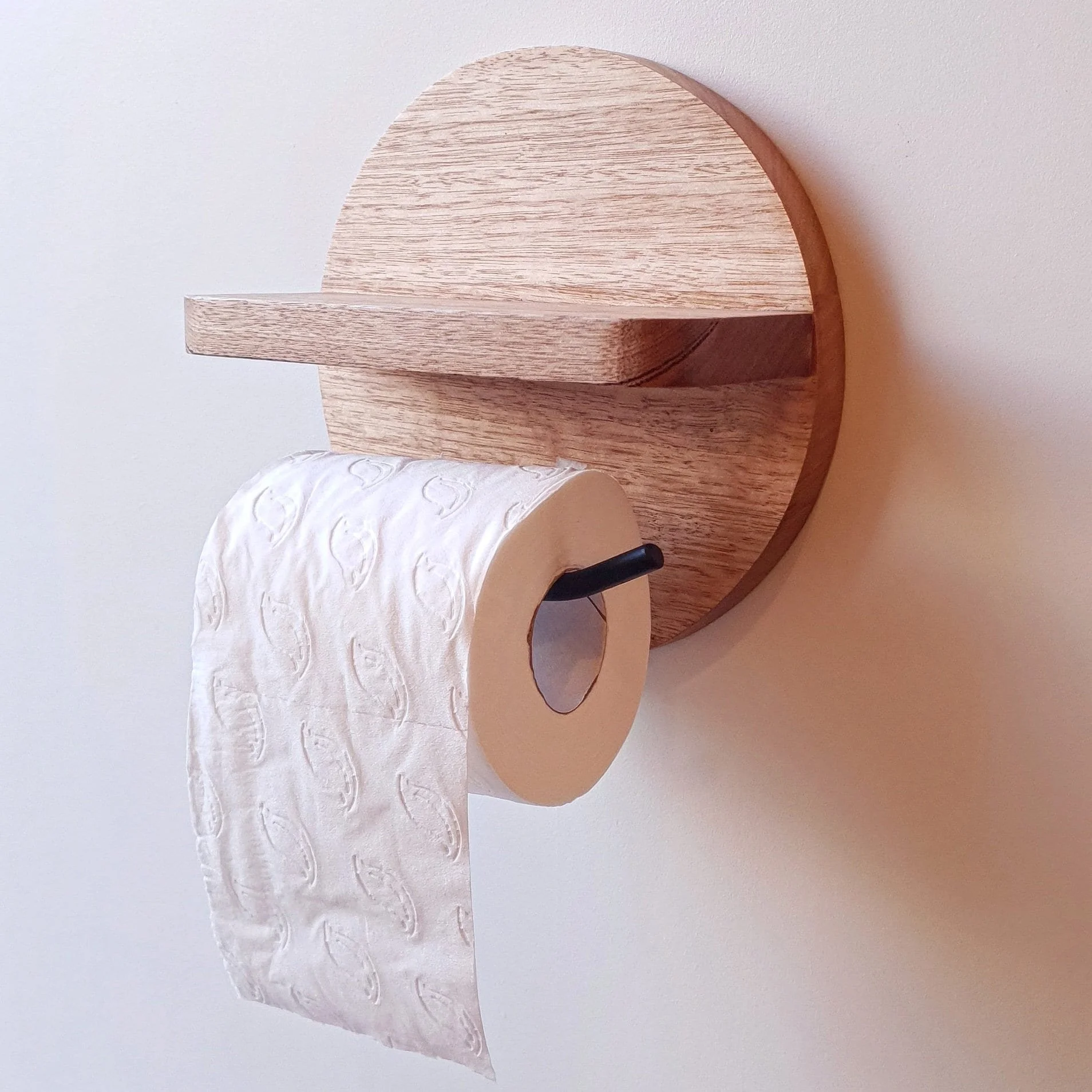 Handcrafted wood and powder-coated steel toilet roll holder with shelf, available in a range of timber finishes and tones.