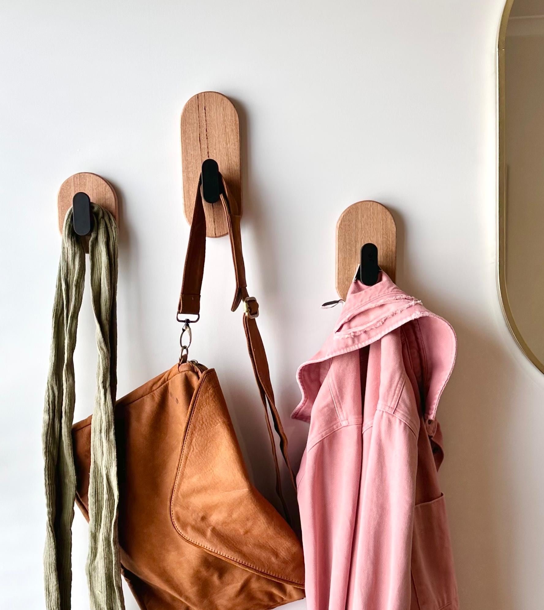 Oak and satin black hooks, stylishly hold clothes & bags.