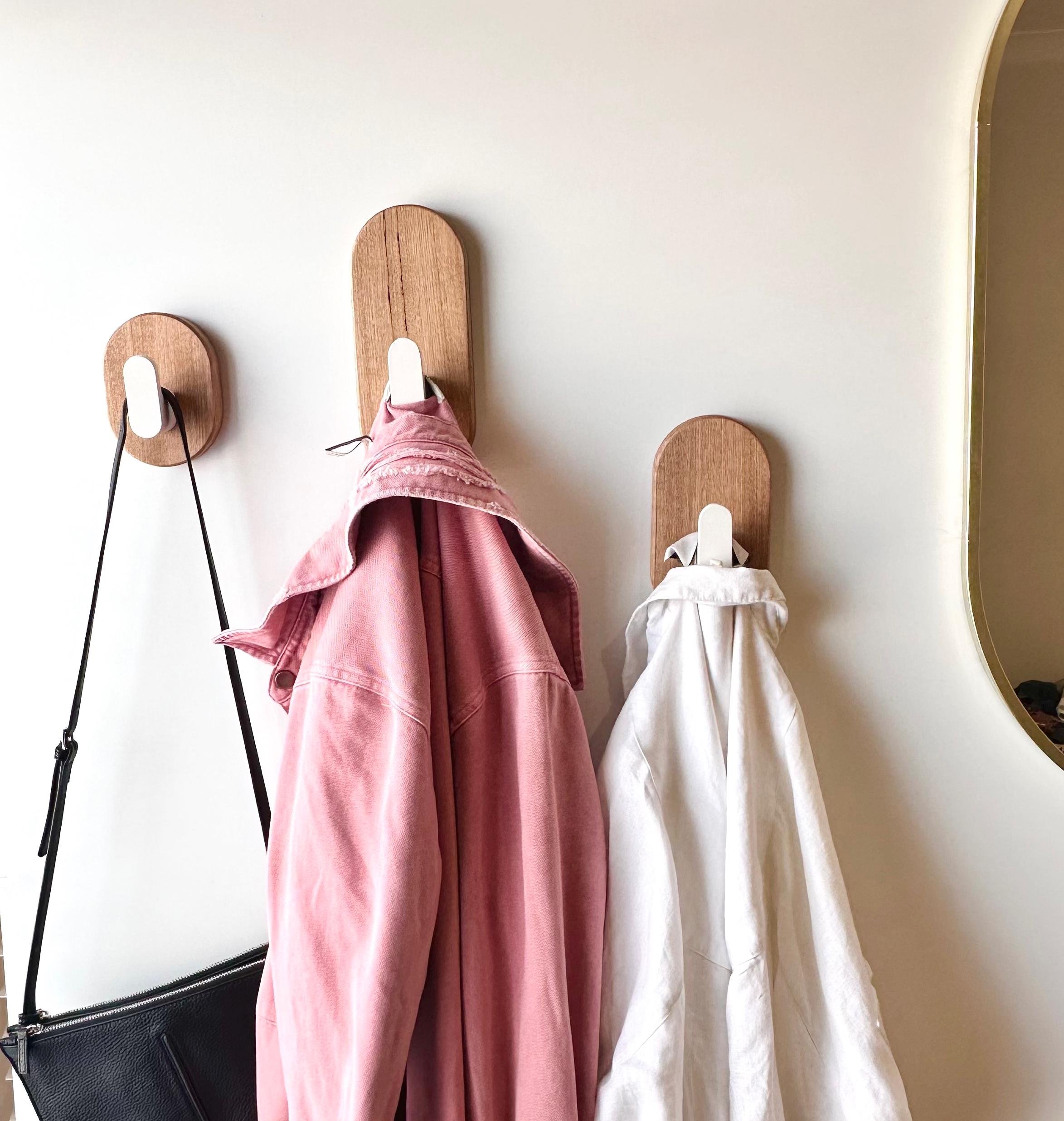 Oak and satin white hooks, stylishly holding clothes & bags.