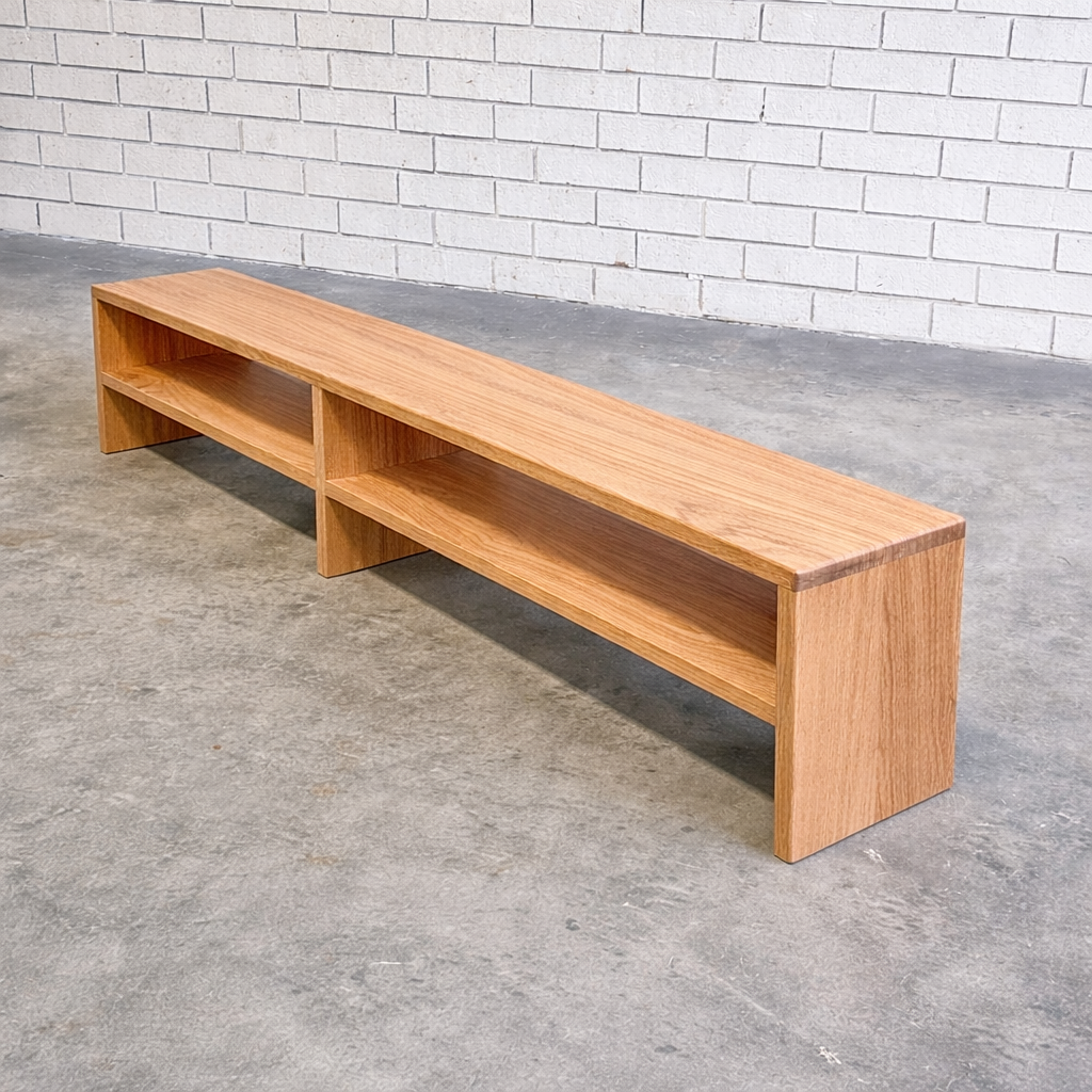 Minimalist oak bench in industrial space.png