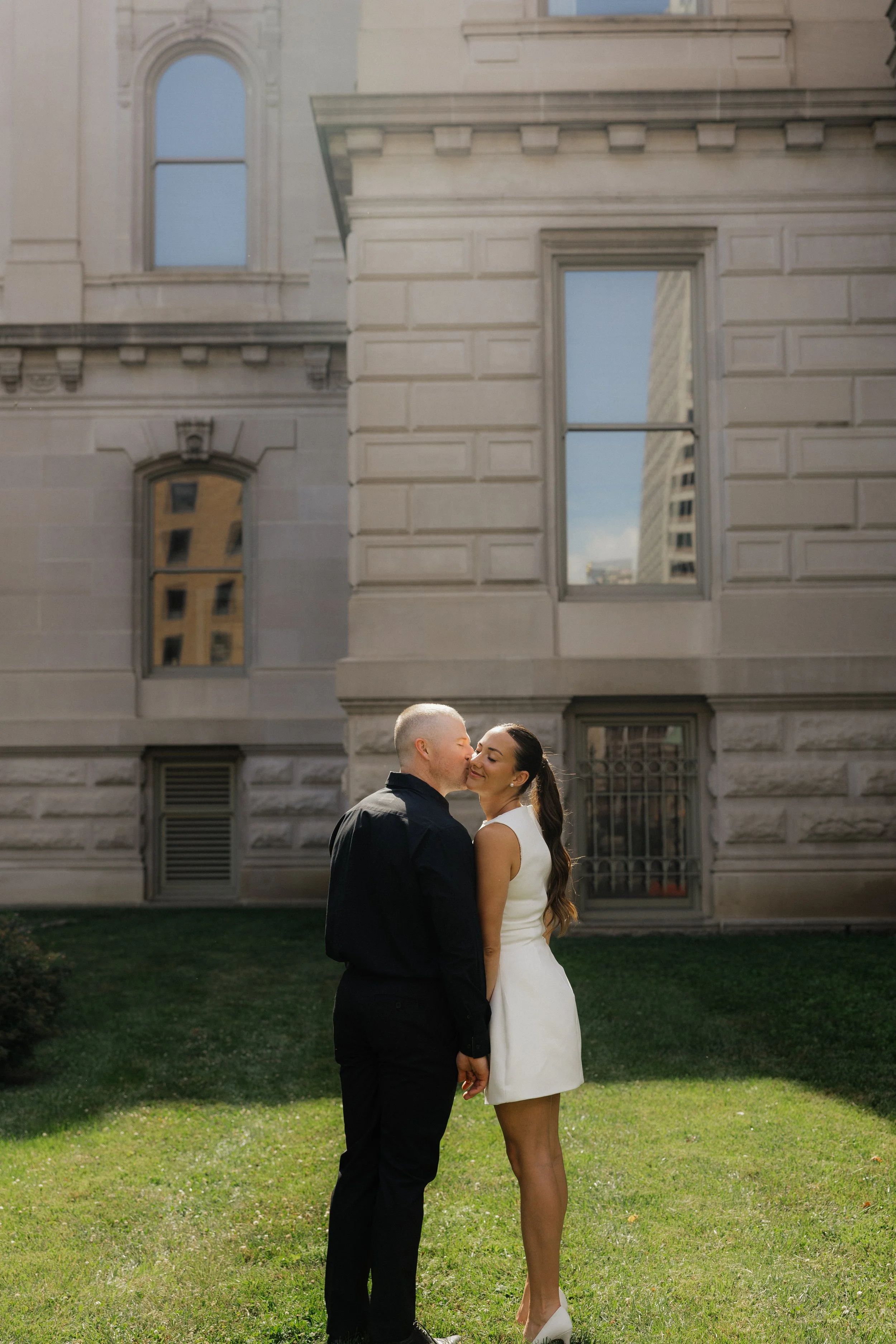 man kissing woman's cheek