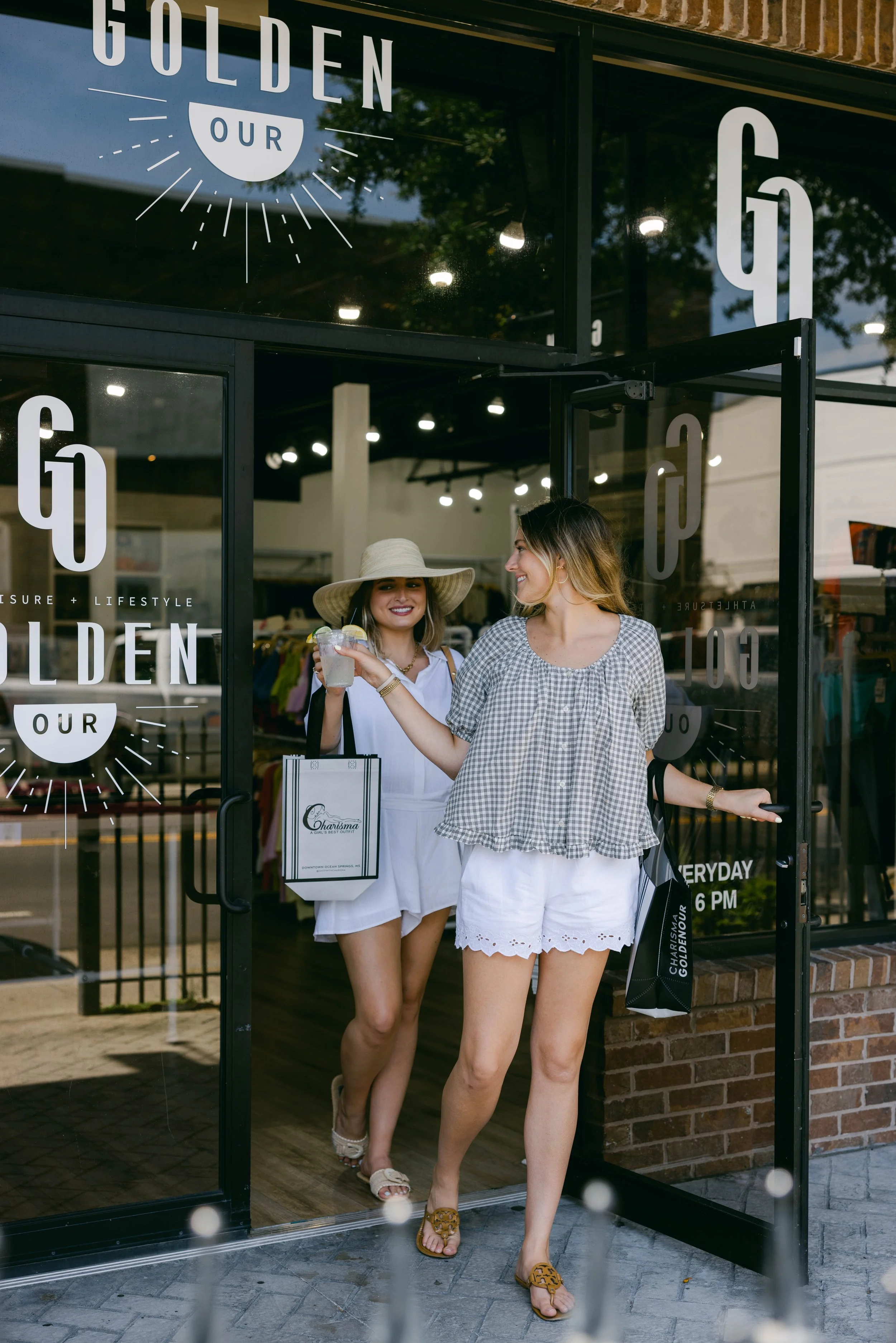 Two women leaving a Washington Avenue shop carrying shopping bags
