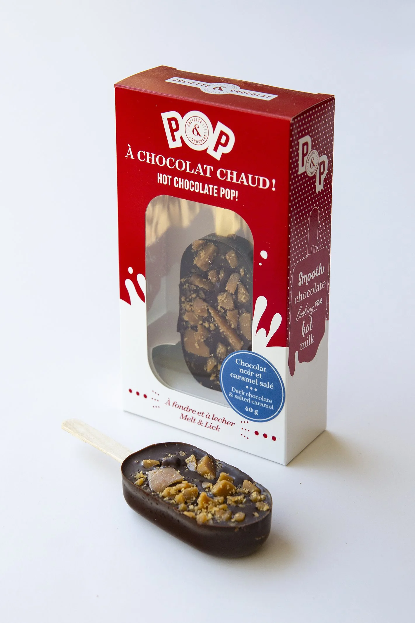 Dark chocolate pop with salted caramel chunks and a bright red retail box. 