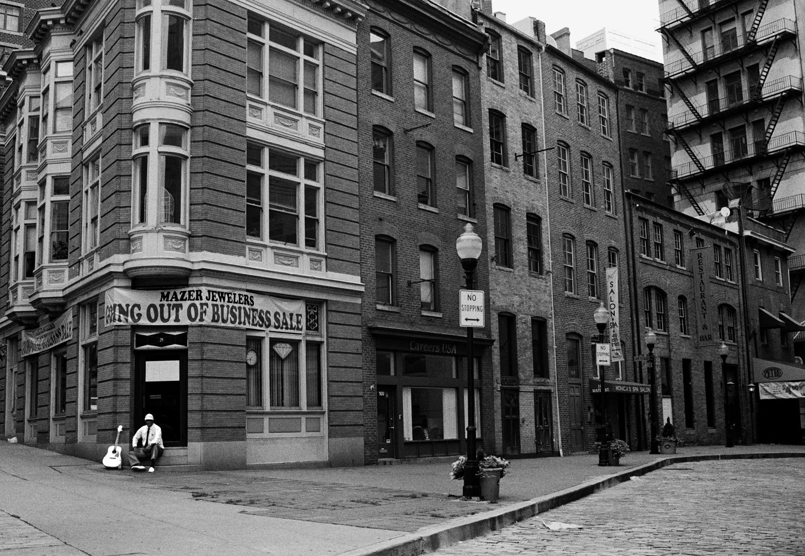 Baltimore, Maryland. Lonely guitar player on empty street, moody and desolate shot. 
