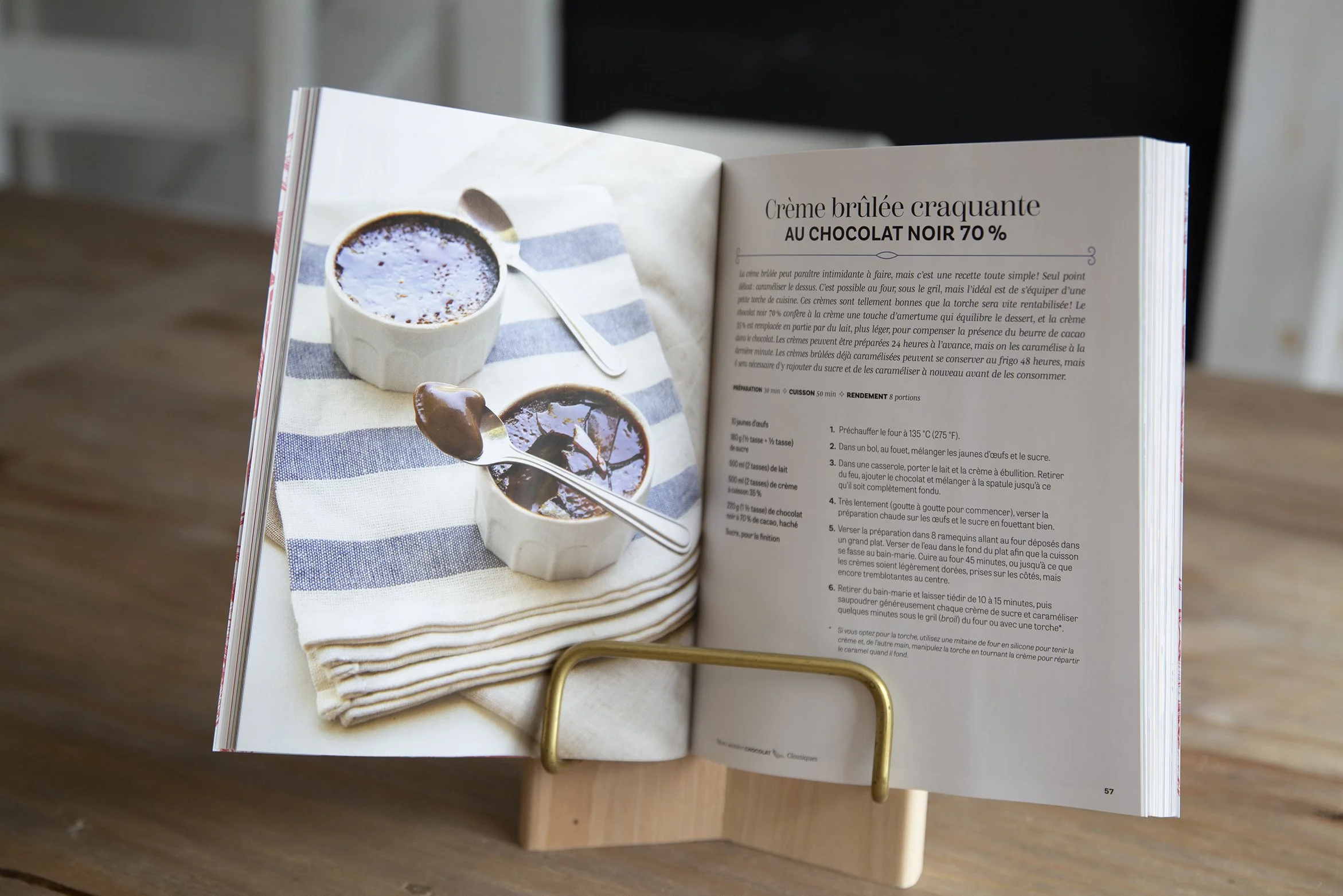 Open dessert cookbook on stand, showing a recipe for a chocolate creme brulee