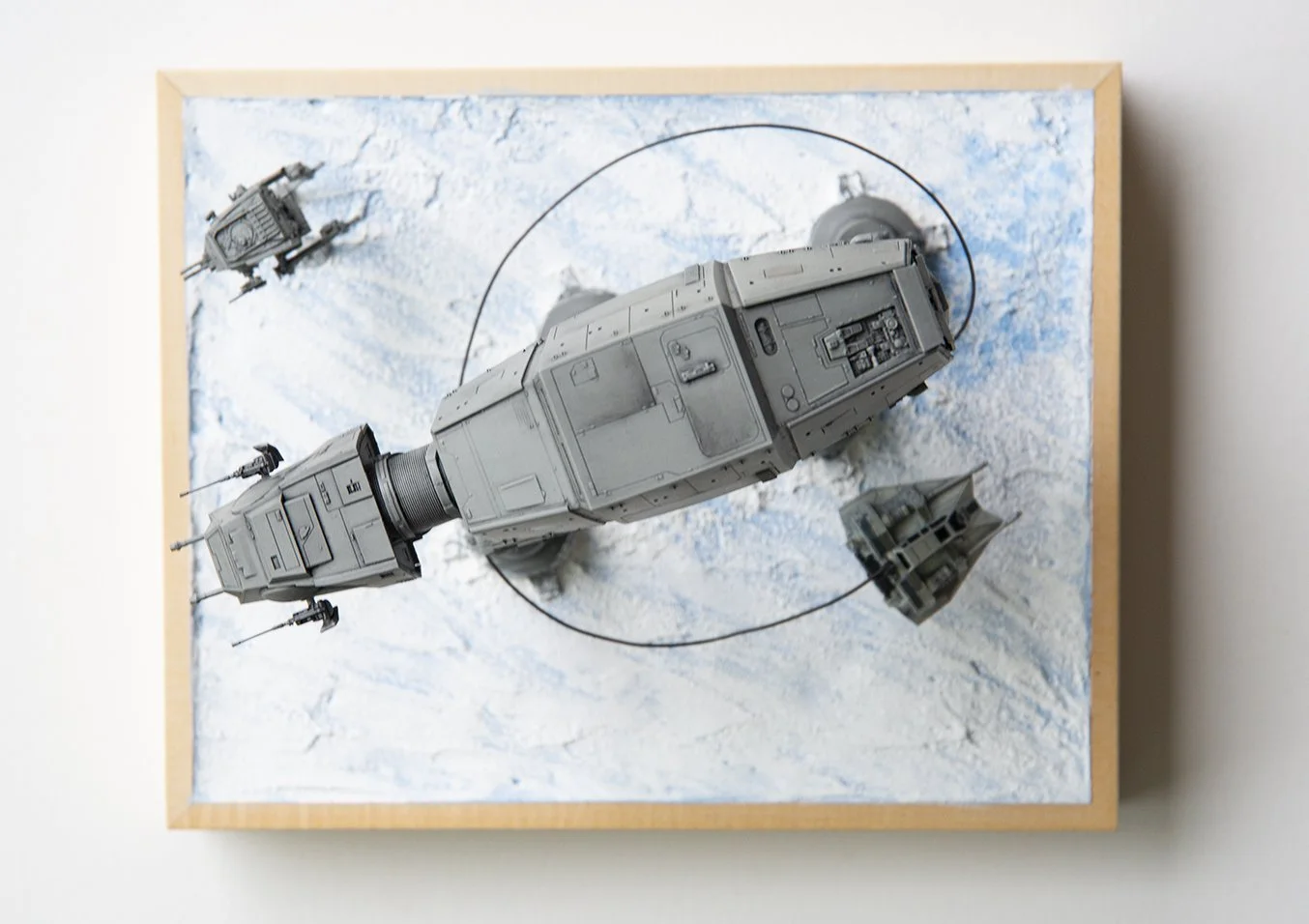 Star Wars AT-AT circled by snowspeeder, scale model scene from The Empire Strikes Back