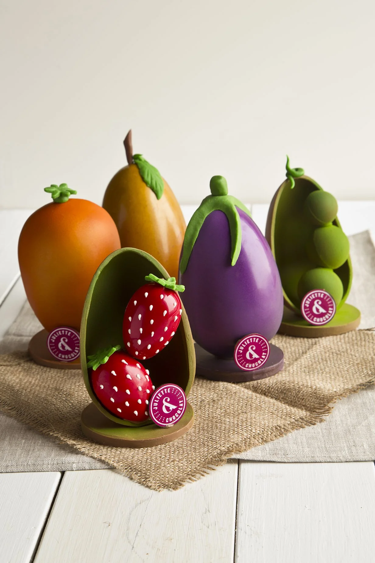 Easter chocolate creations, chocolate eggs decorated like strawberries, oranges, peas and aubergine