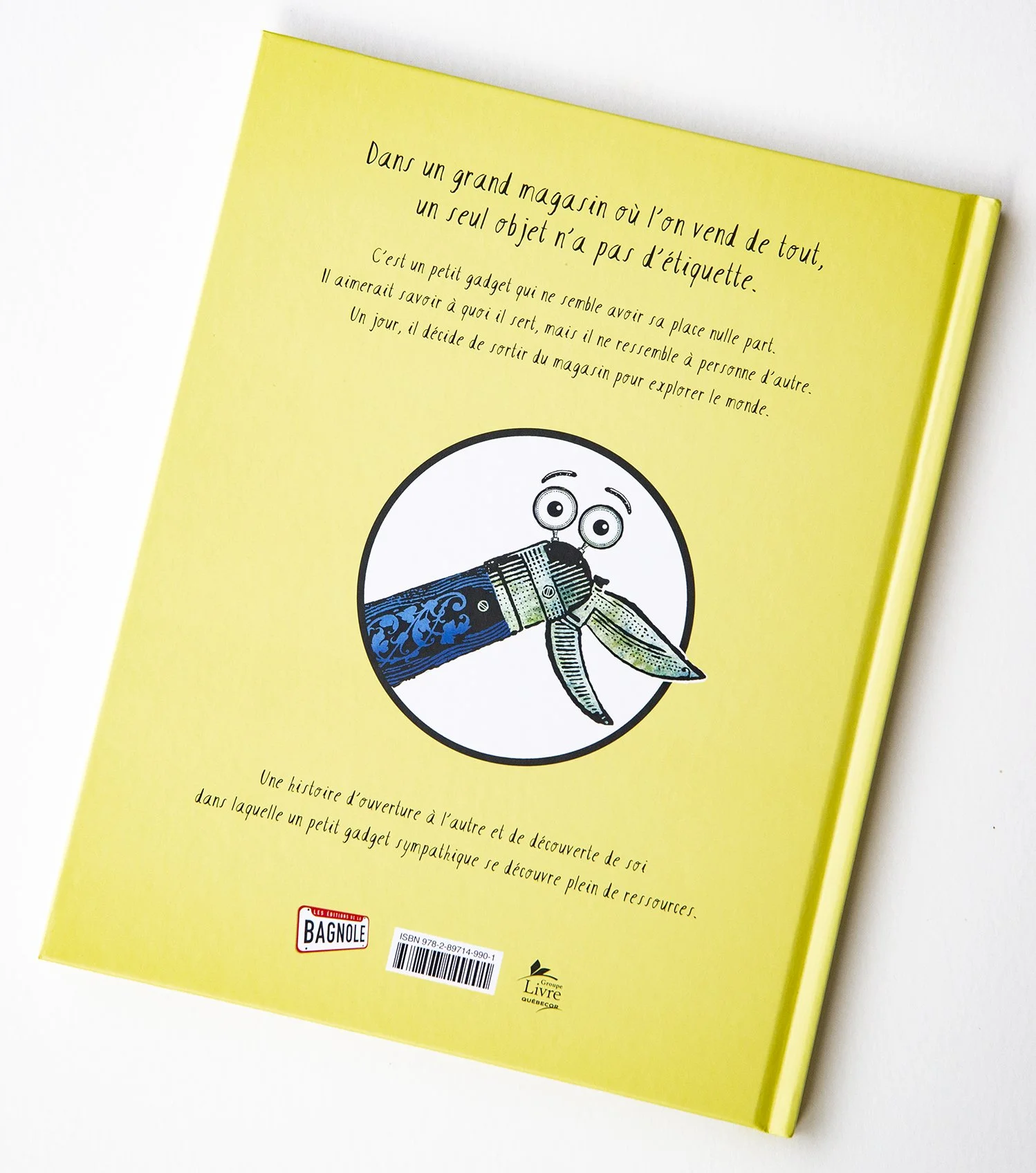 Back of yellow children's book by Lionel May showing a smiling mechanical gadget