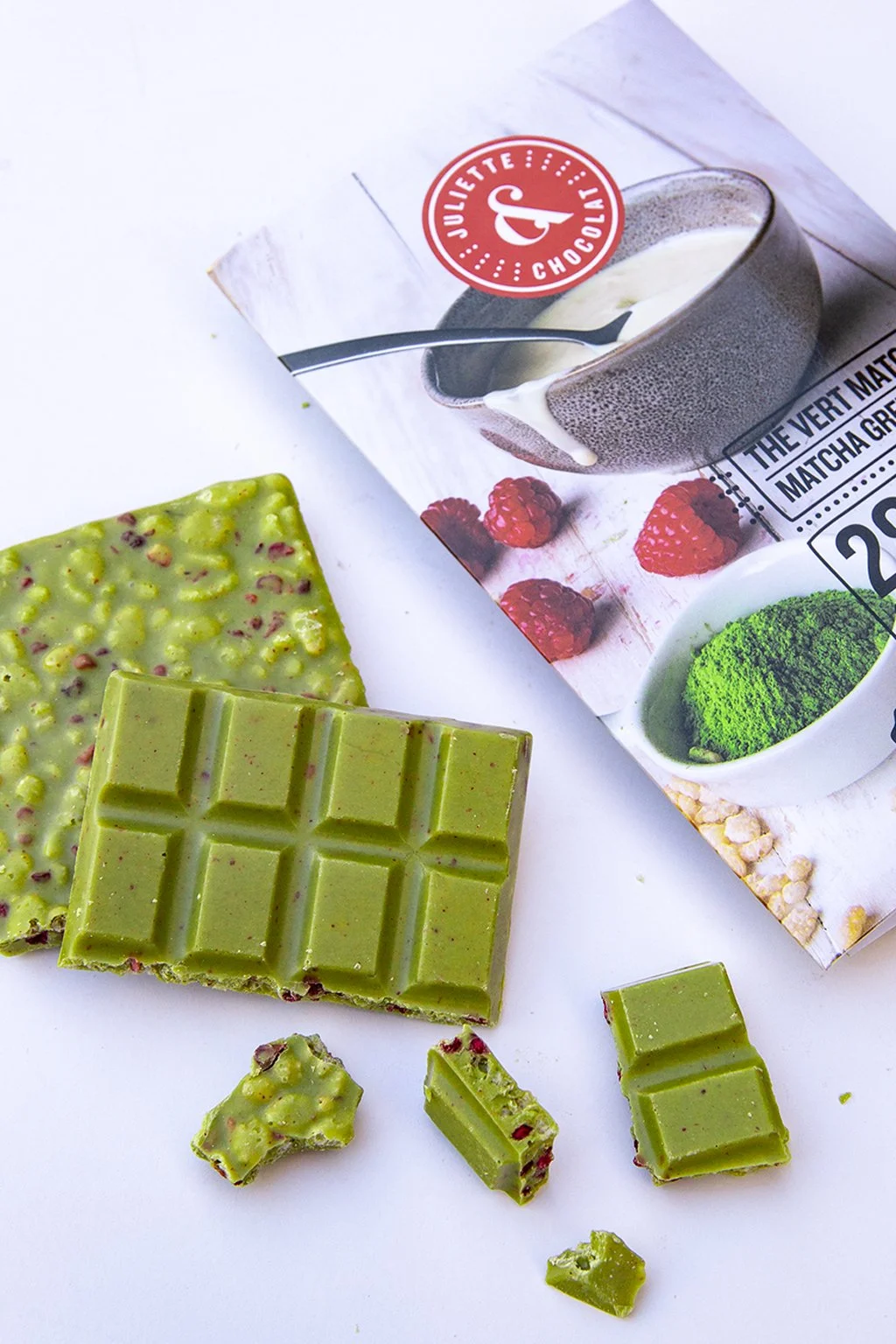 White chocolate and matcha chocolate bar on white background with colorful packaging. 
