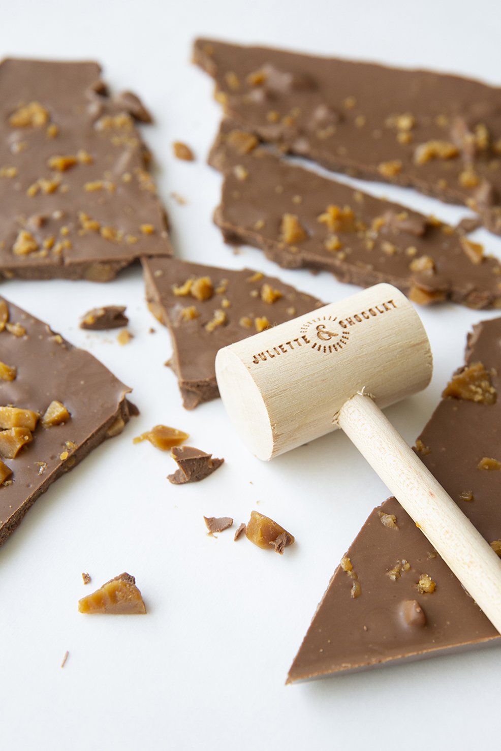 Large milk chocolate bar broken in pieces, with wooden hammer inscribed Juliette & Chocolat