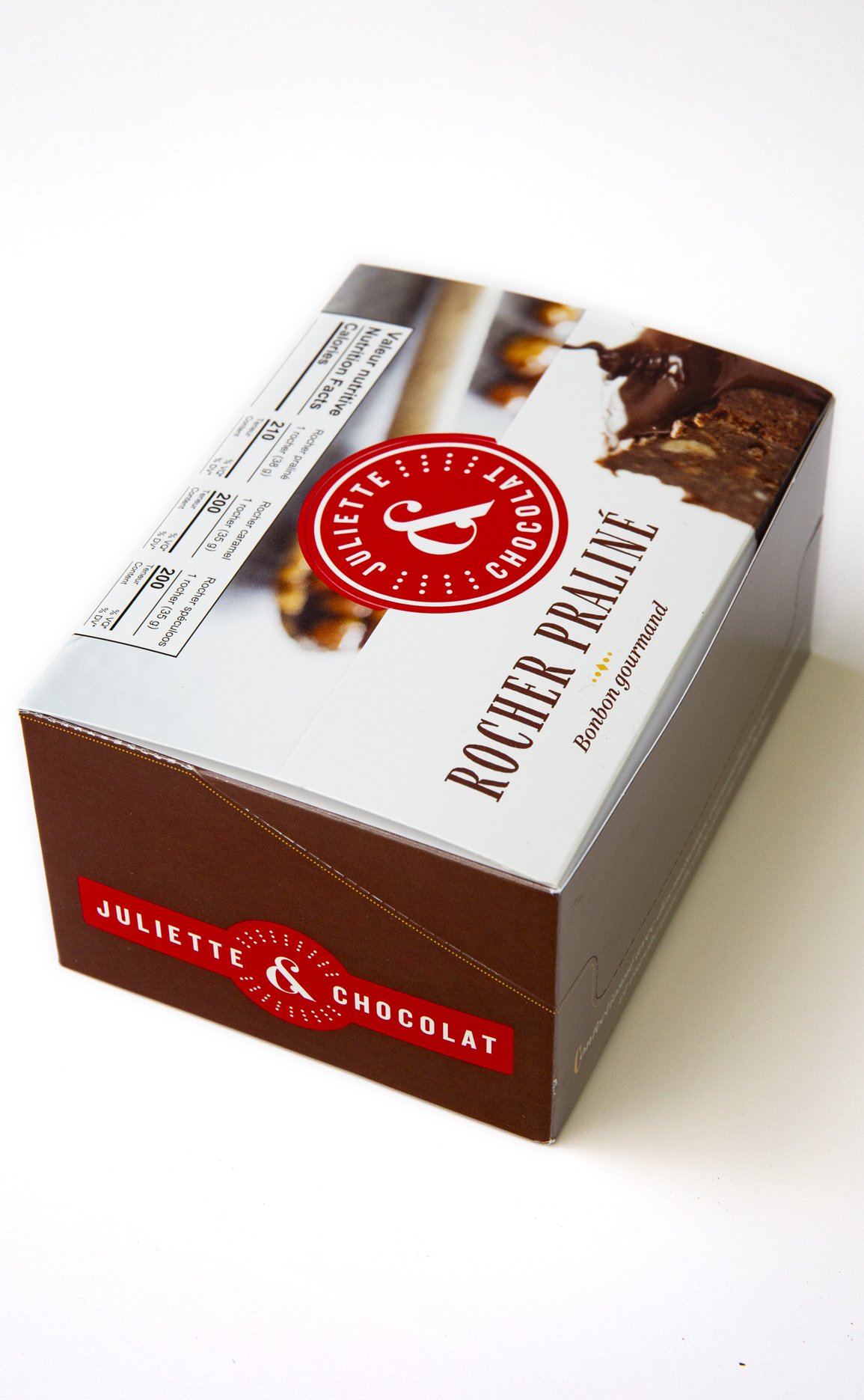 Red and white packaging box for chocolate confections, with photo of milk chocolate confections