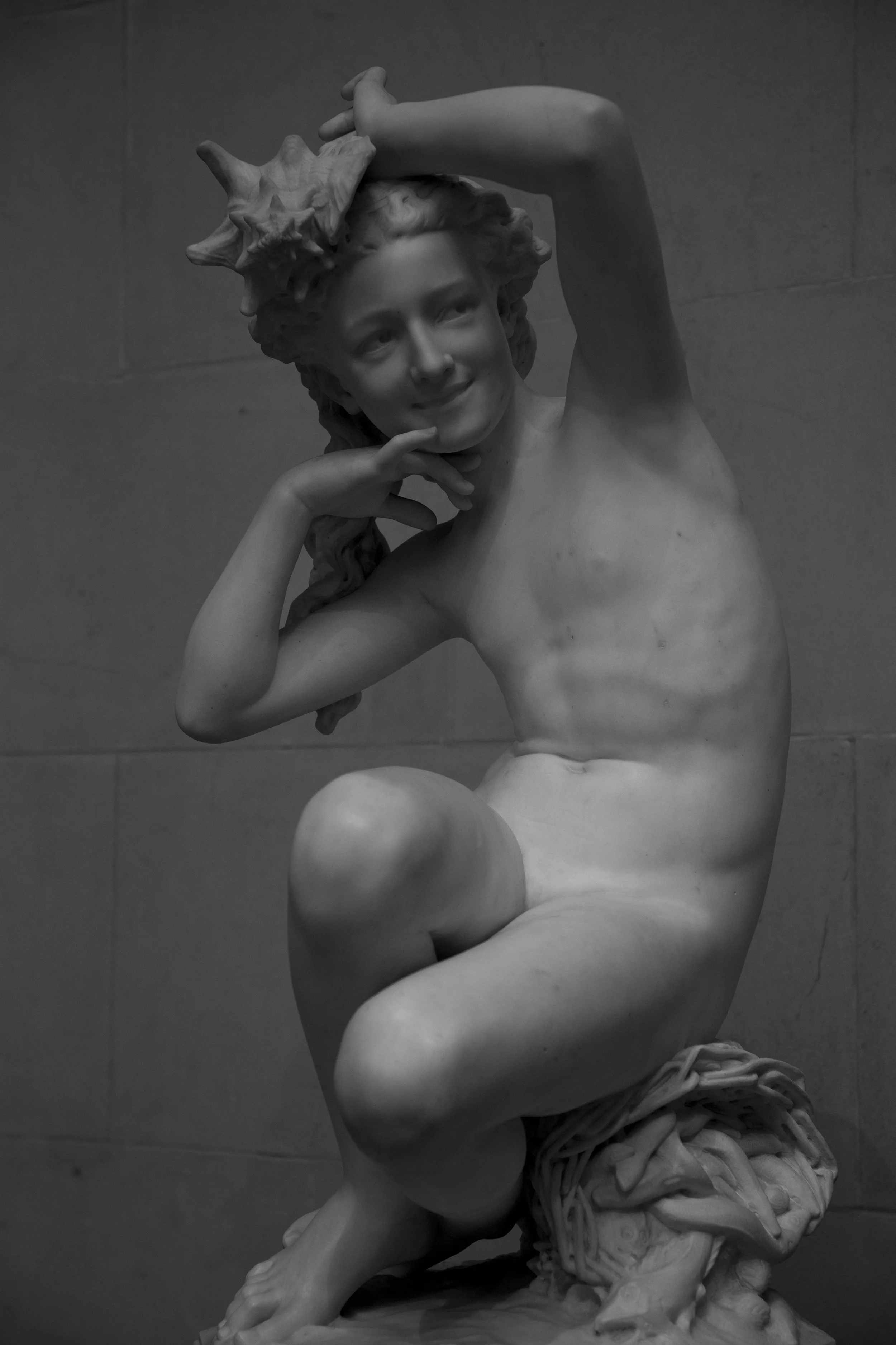 Statue of smiling boy, classical art in museum setting at the National Gallery, photo by Lionel May