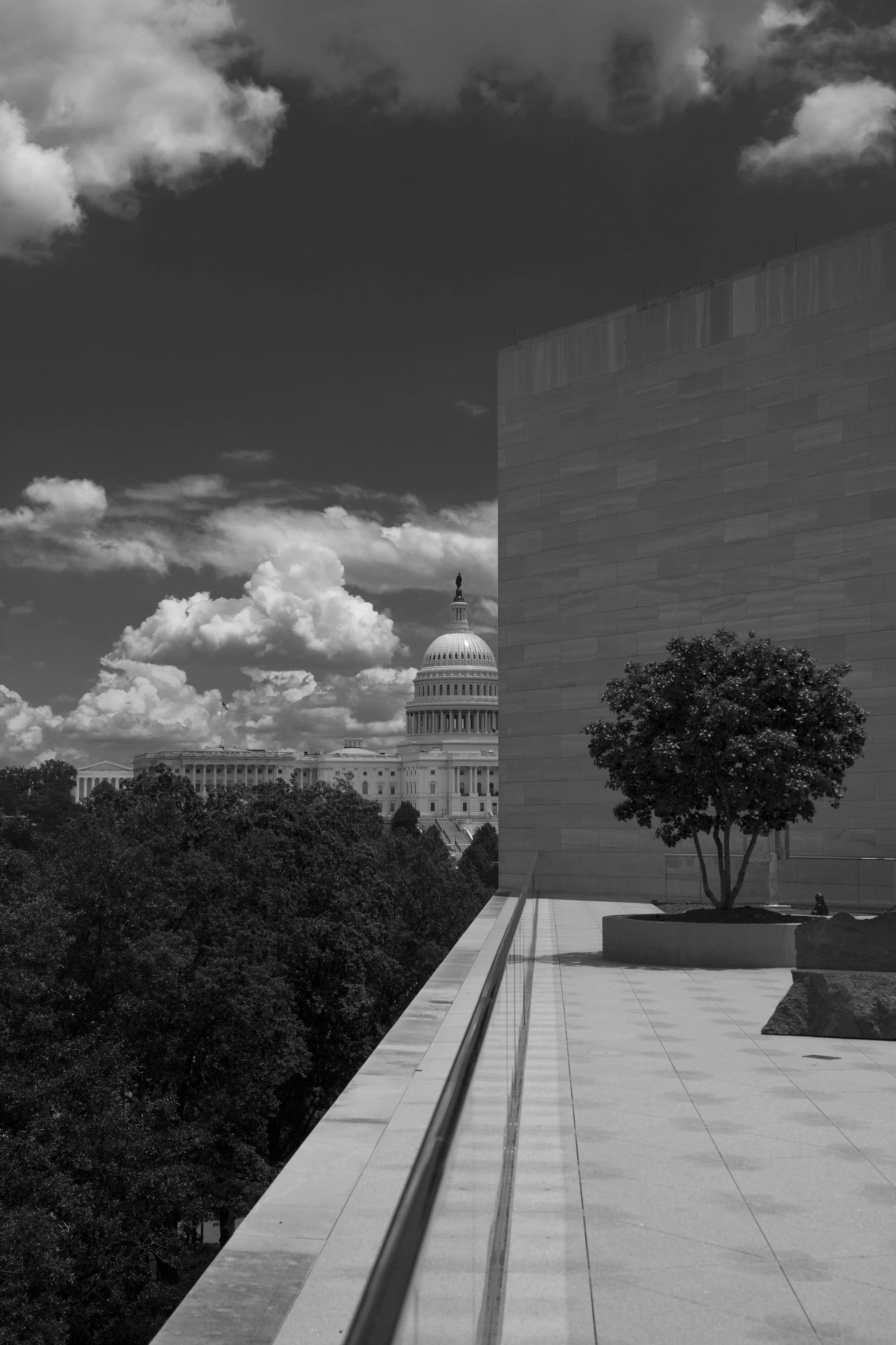 Rooftop view of the National Art Gallery in Washington DC, with white clouds against dark sky, dramatic view