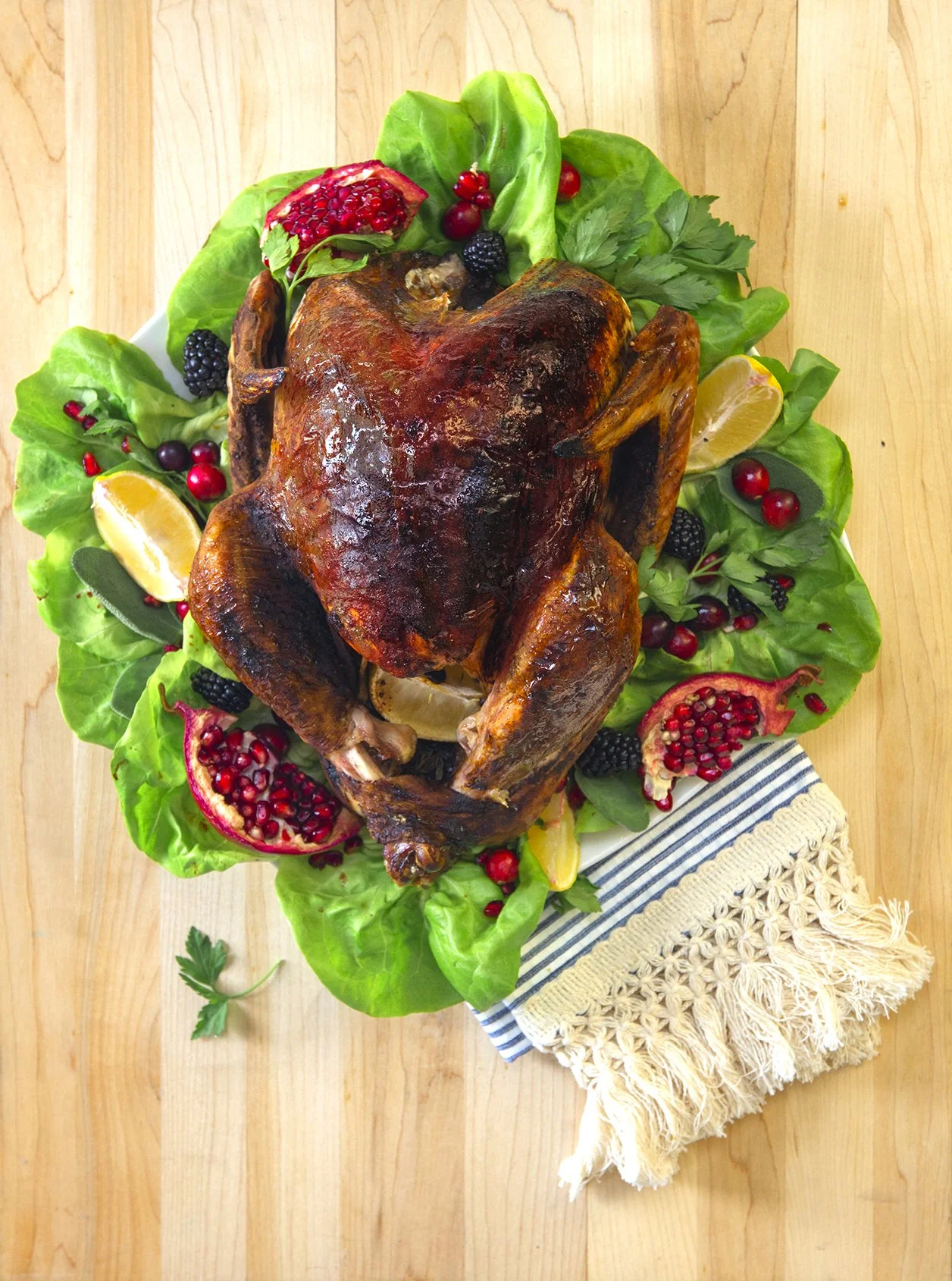 Christmas roasted turkey dusted with cocoa, on bed of lettuce on beautiful wooden table. 