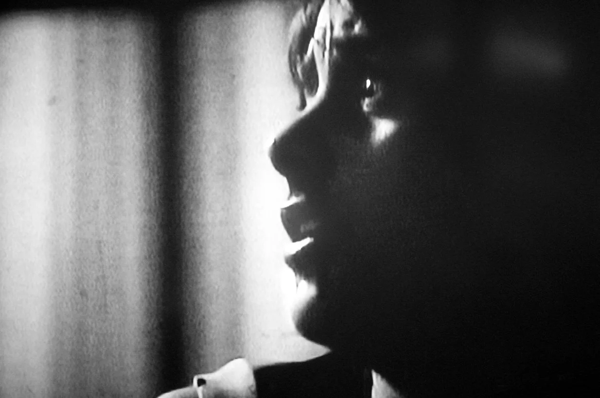 Black and white film still, young scared girl from a horror movie 