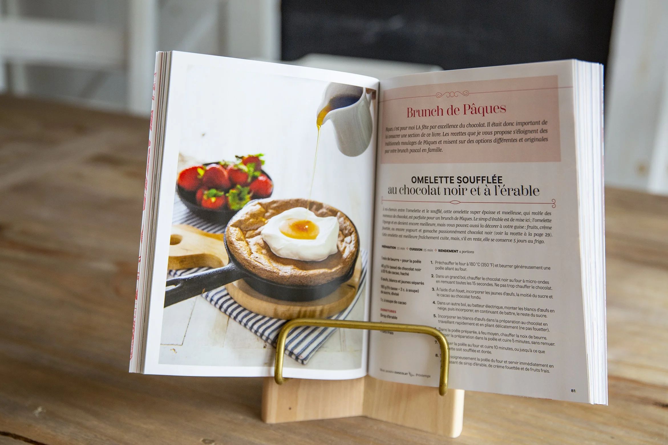 Cookbook om kitchen stand on counter, showing a double page spread with a chocoalate souffle omelette
