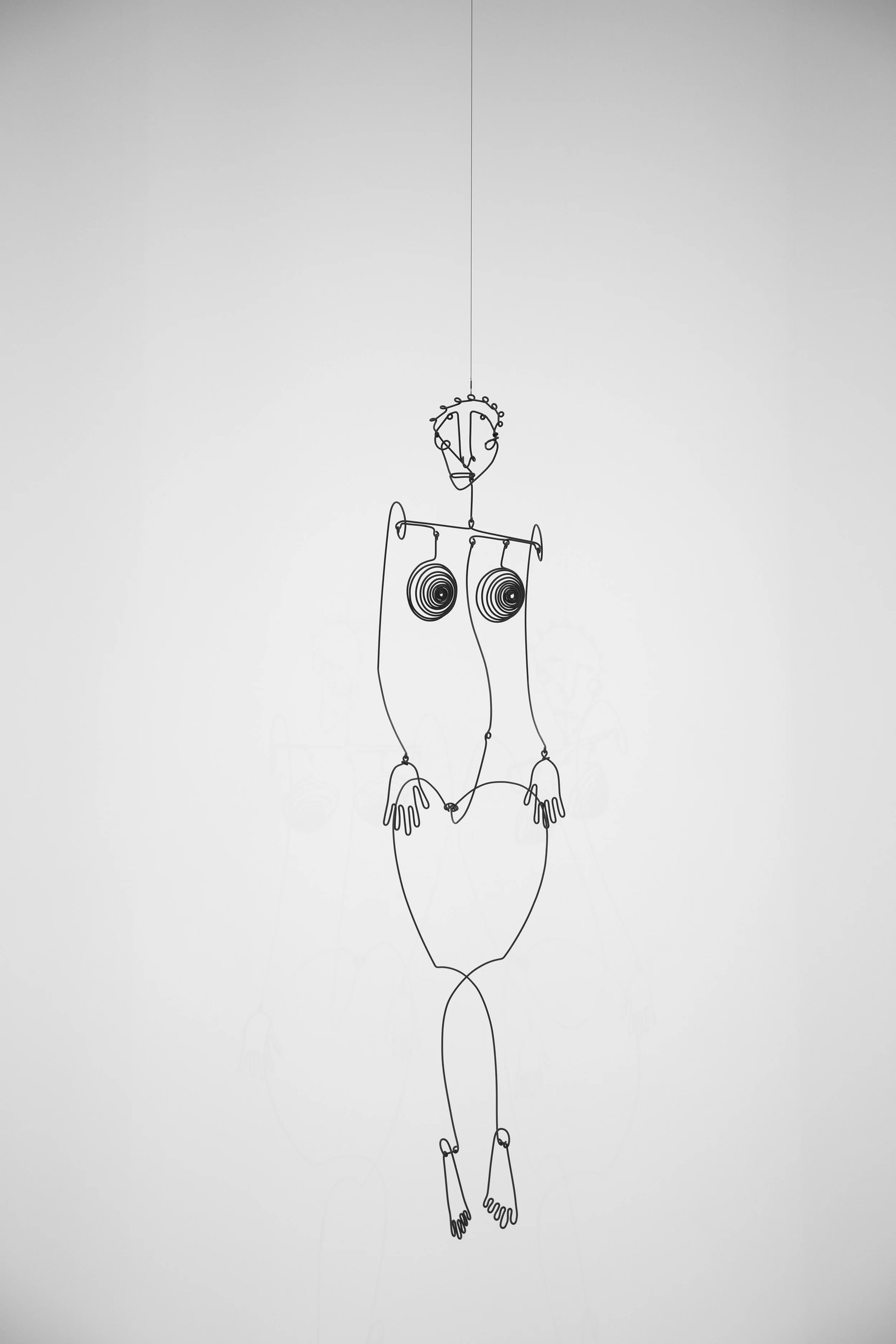 Wire sculpture of a woman, art hanging from the ceiling in the National Gallery in DC, USA.