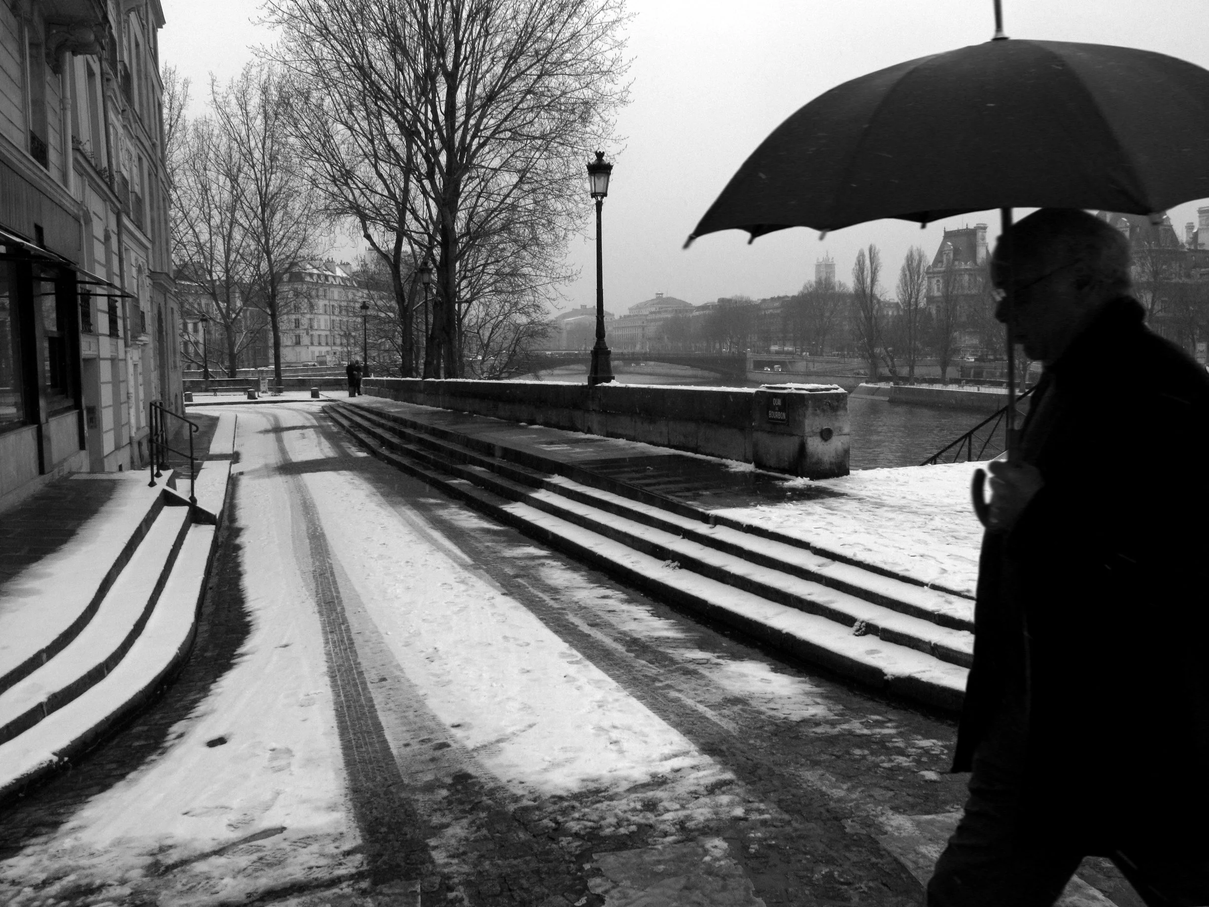 The Ile St-Louis in Paris, France, winter photo of fresh snow and silhouette, black and white.