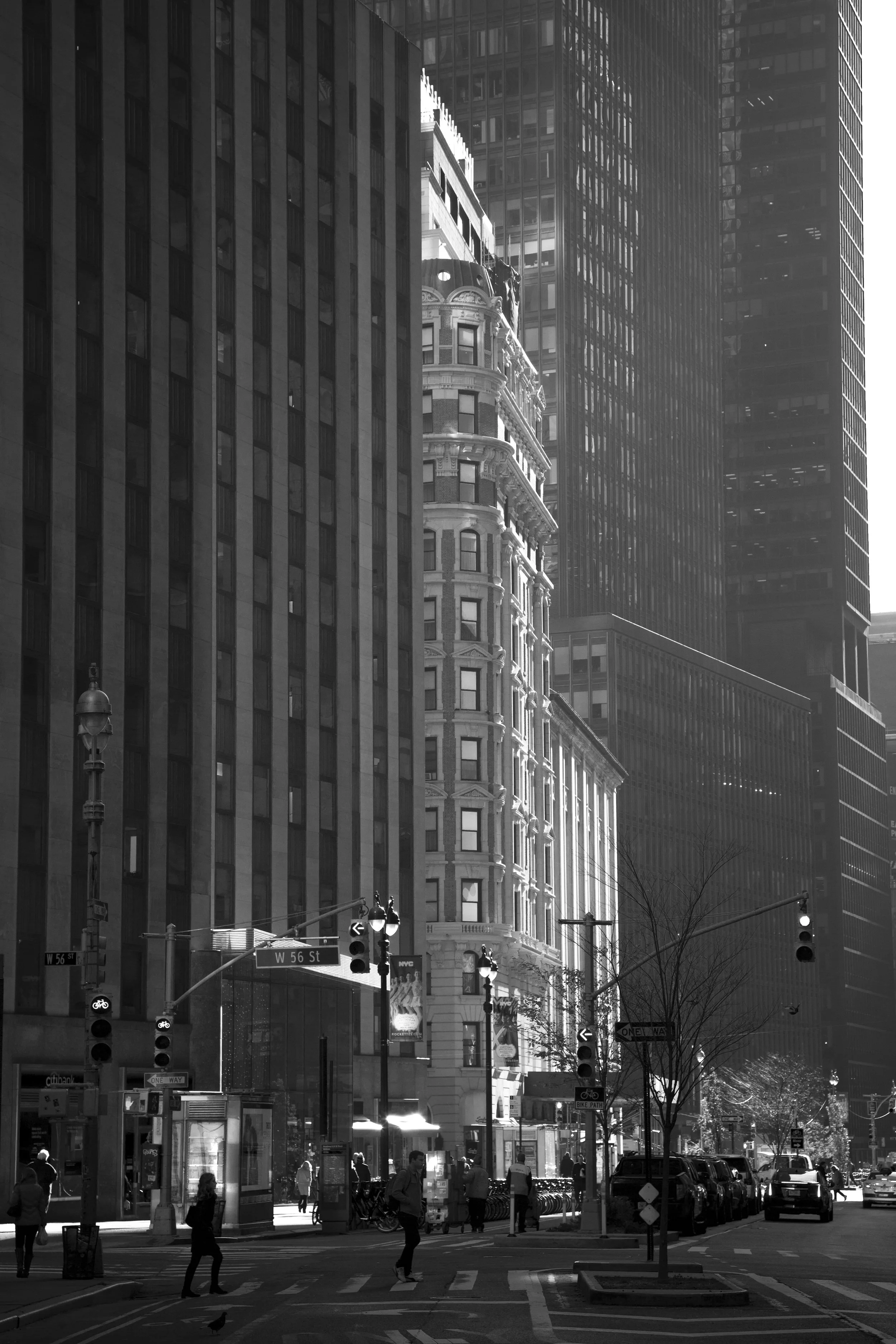 Manhattan street in black and white, tall buildings with windows and street traffic, geometric composition